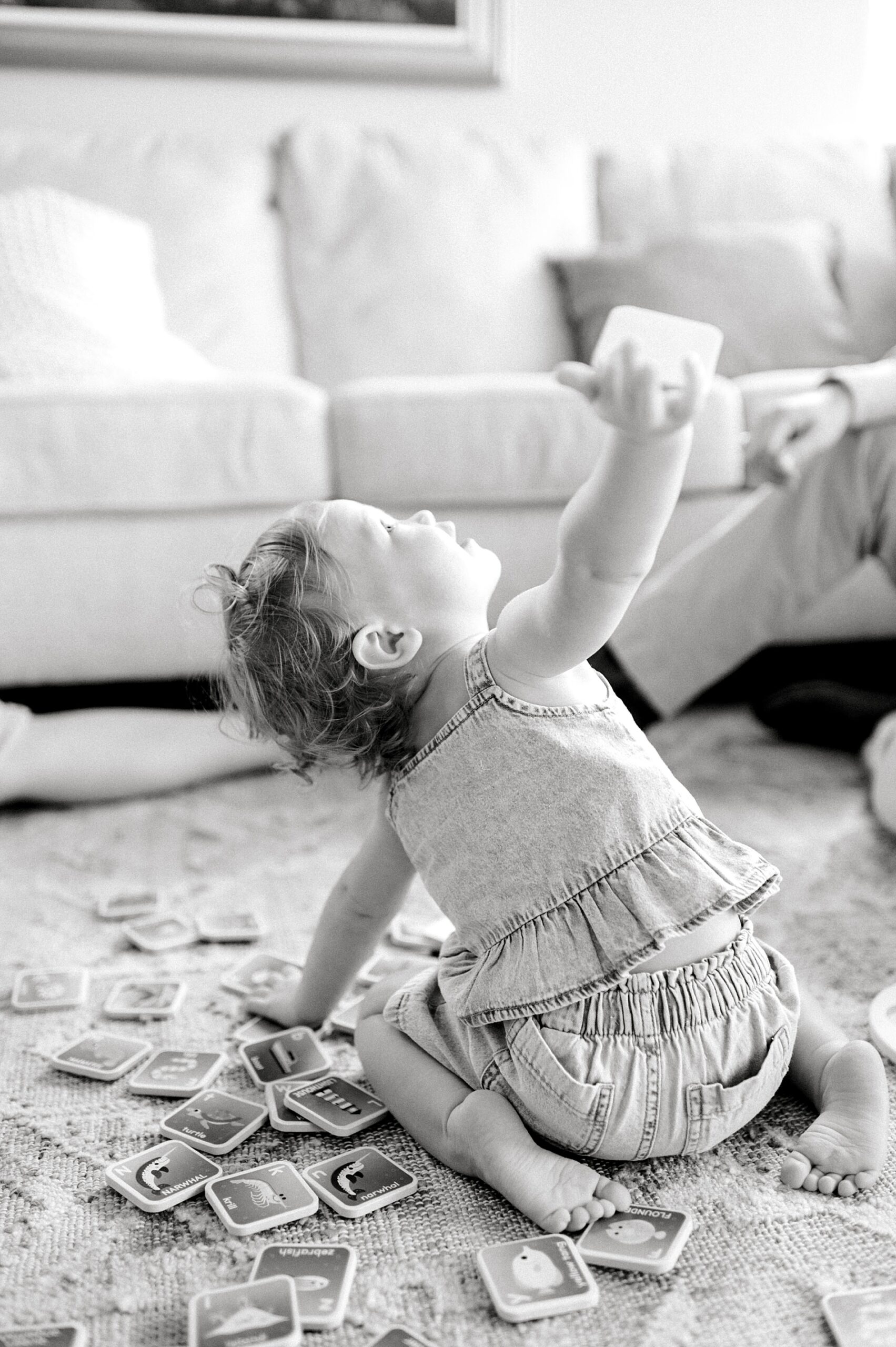 little girl plays on living room floor