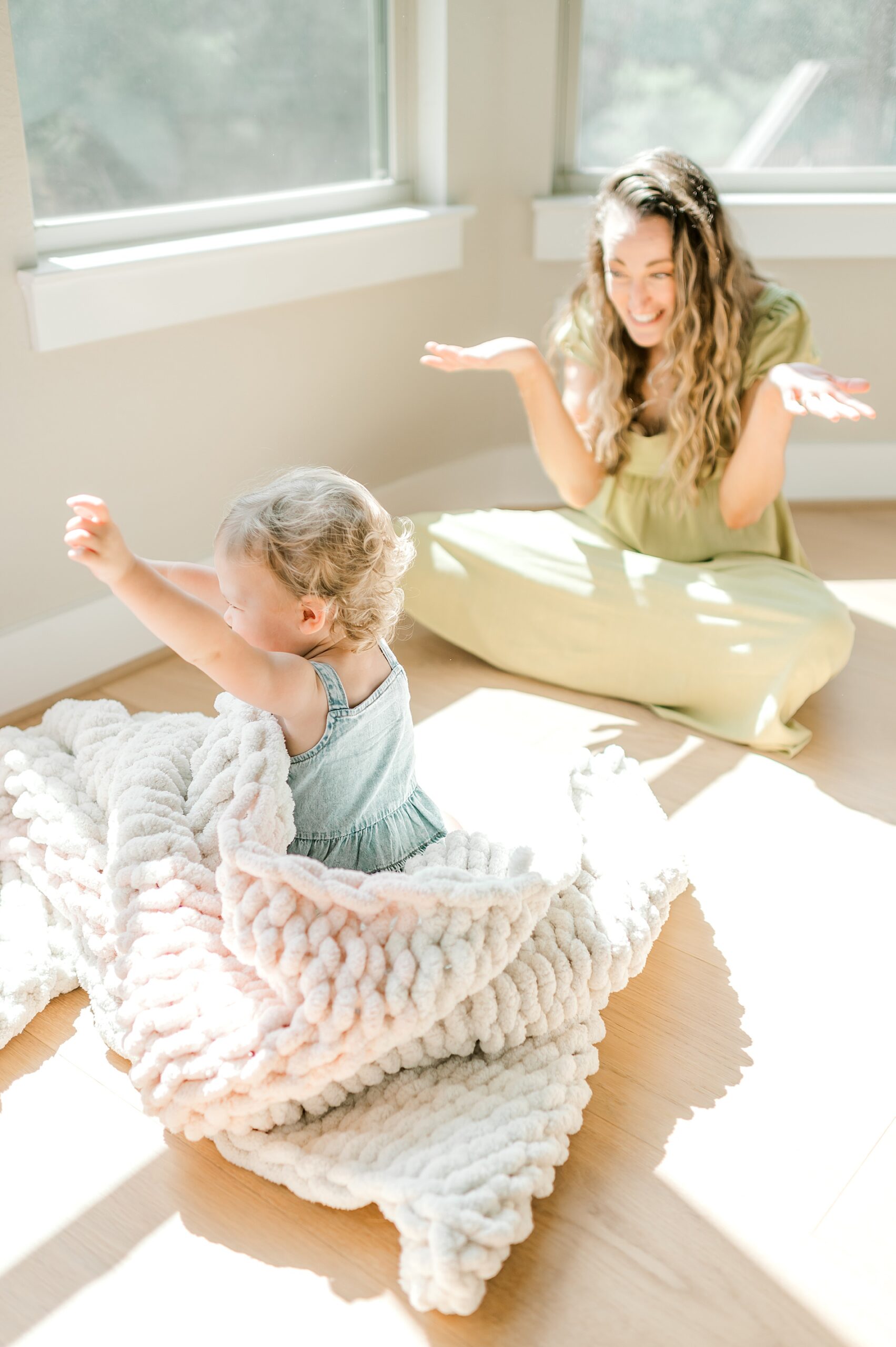 daughter plays peek-a-boo with mom