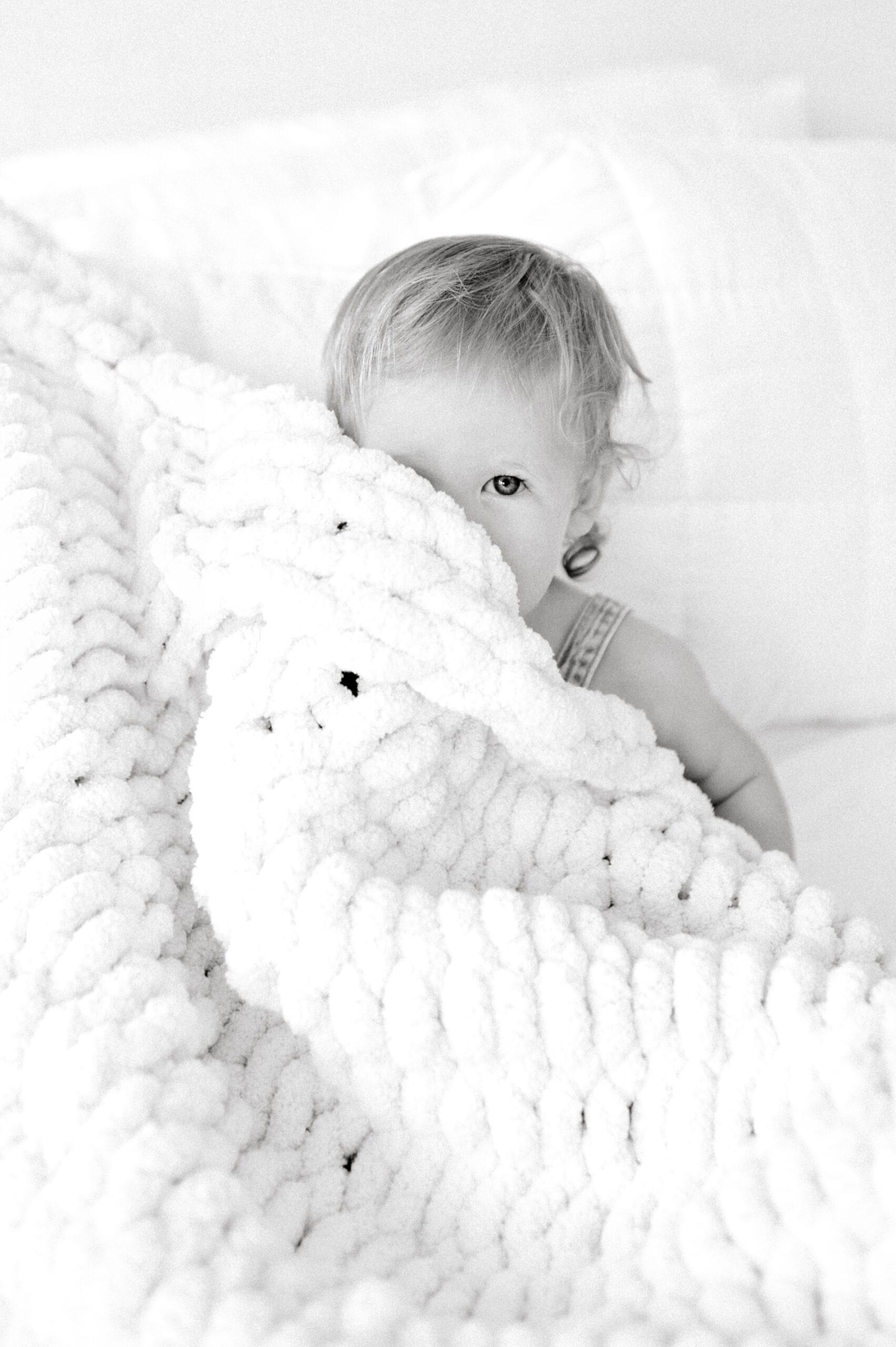 little girl hides under blanket during Candid In-Home Family Session