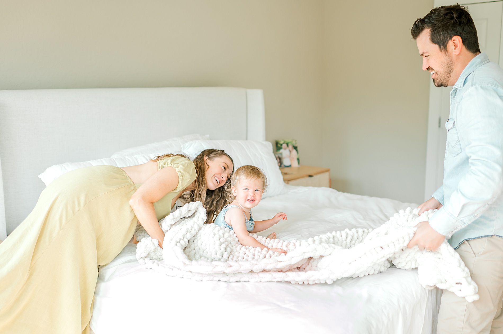 parents play peek-a-boo with daughter