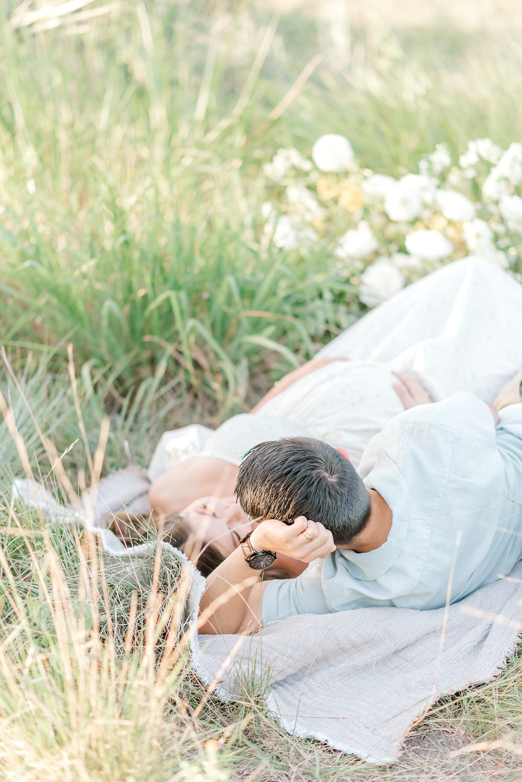 couple lays together on blanket during Whimsical Maternity Session 