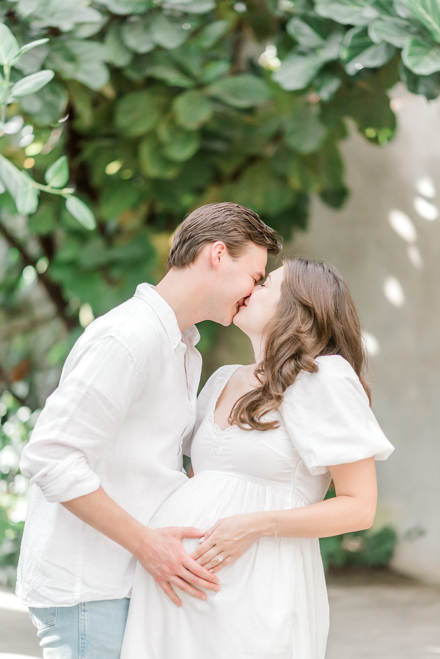 couple kiss during Garden Maternity Session  