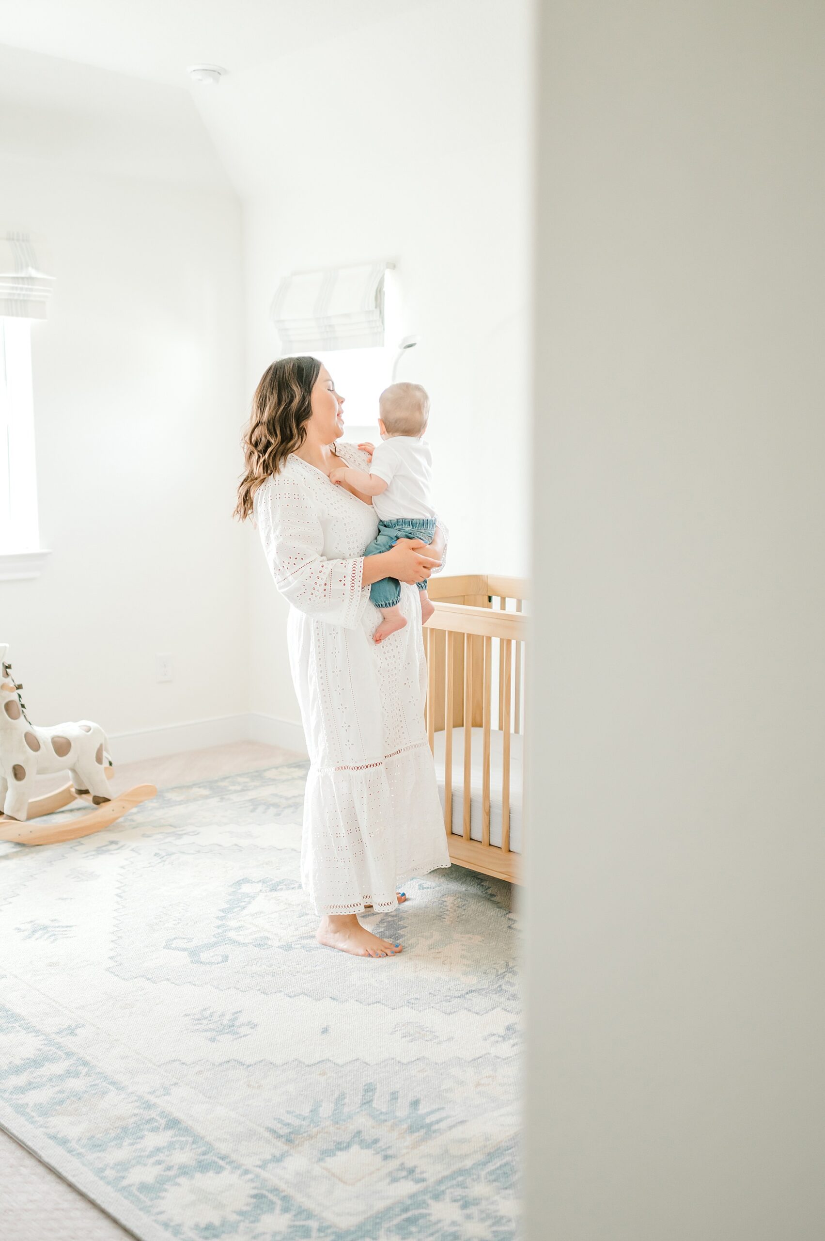 mom and baby in nursery during Light and Airy One-Year Milestone Session