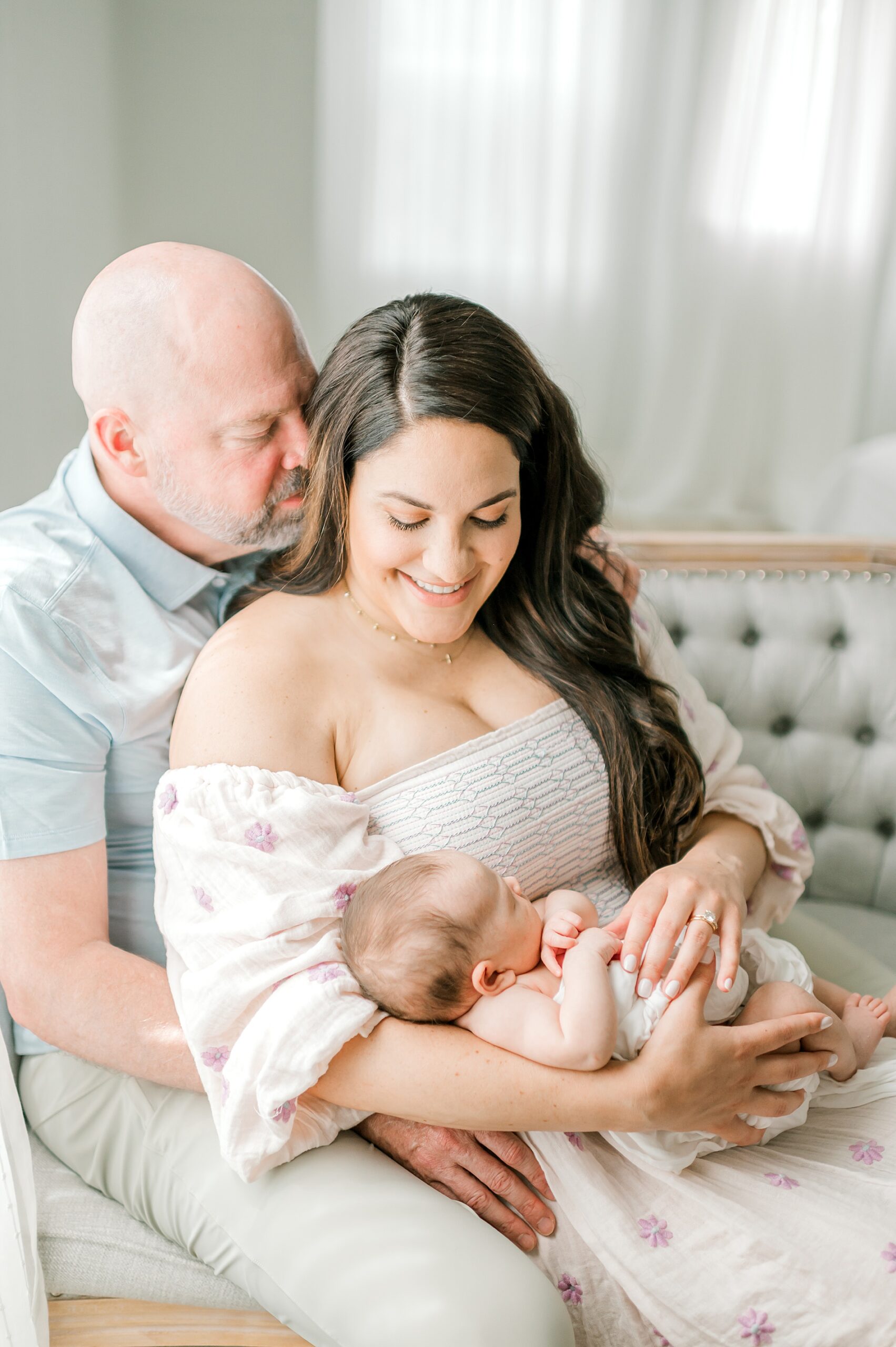 parents hold sleeping newborn during Timeless Studio Newborn Session