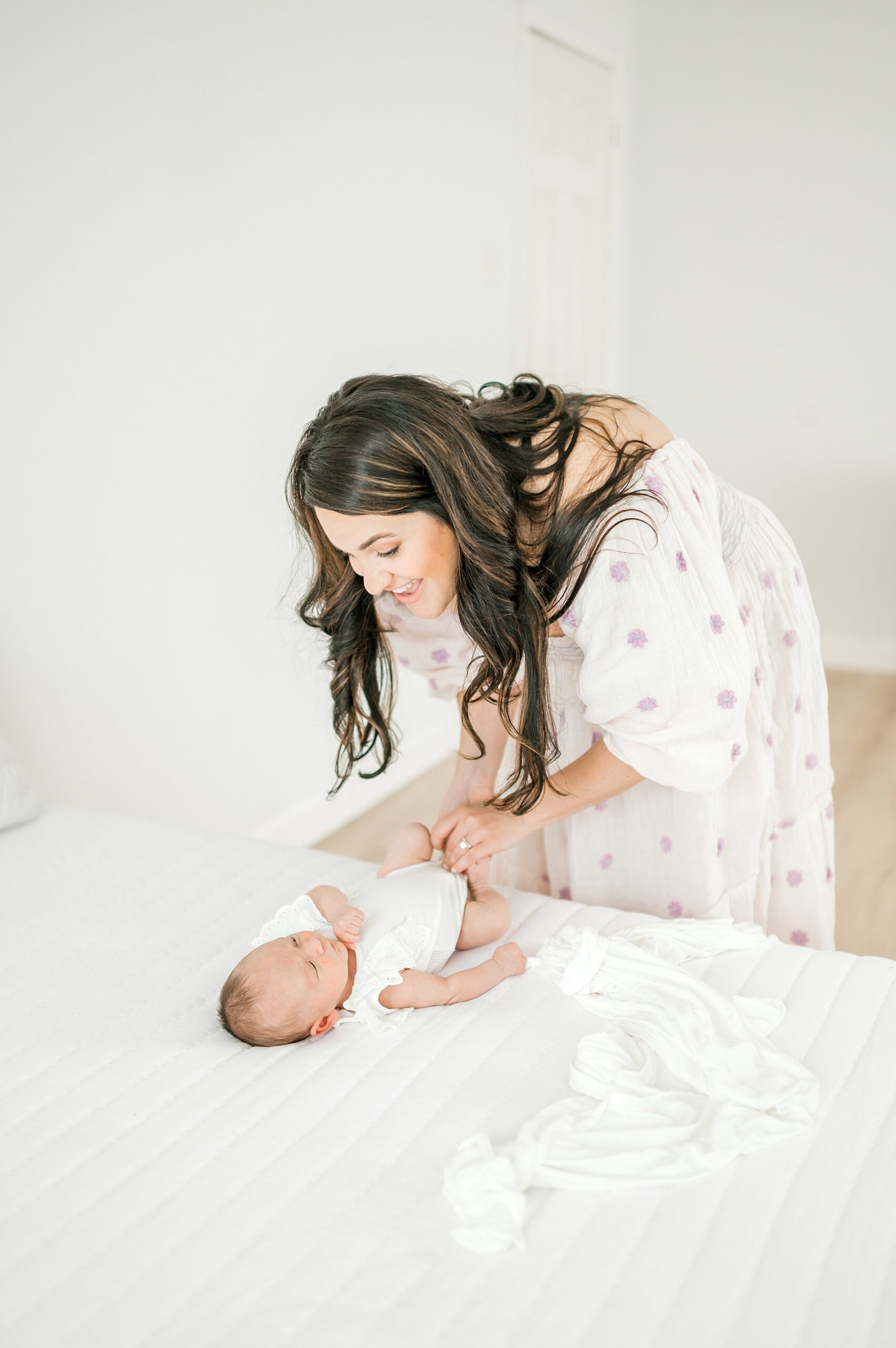 mom changes baby during newborn session 