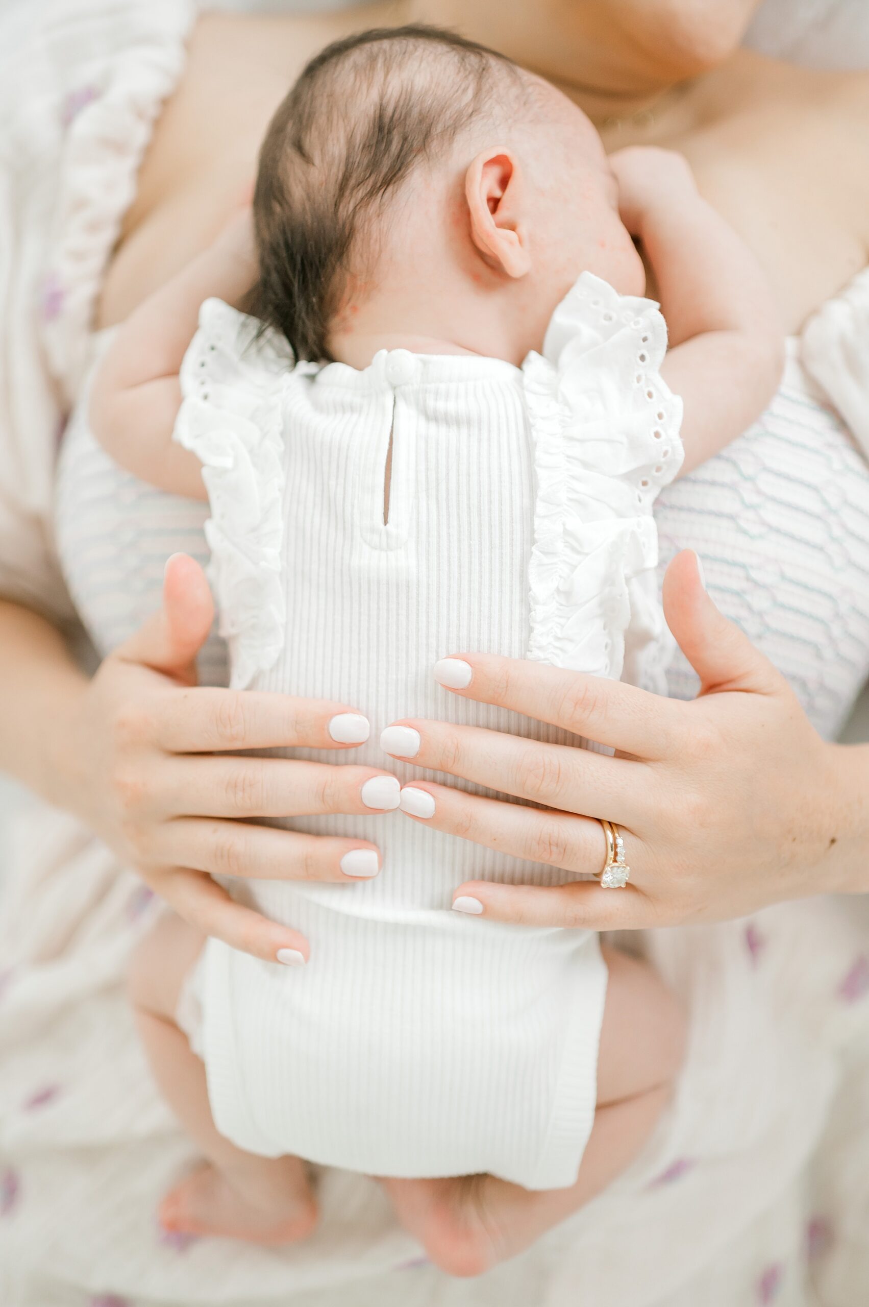 newborn sleeps on mom during Timeless Studio Newborn Session