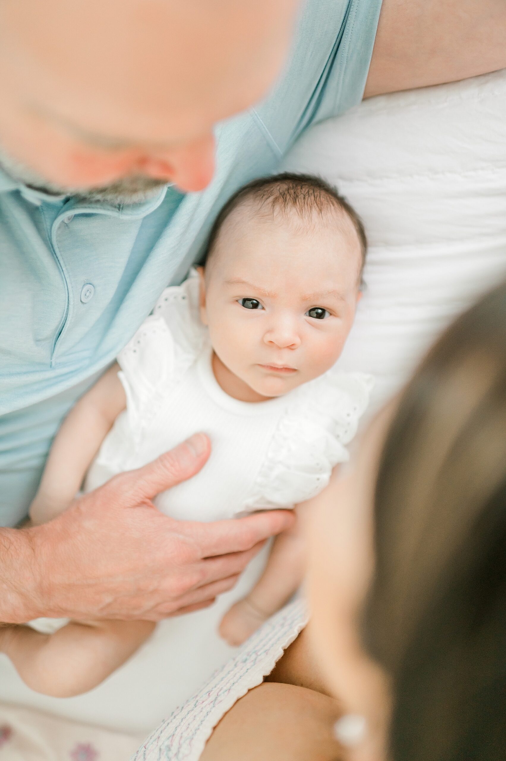 parents look down at newborn 