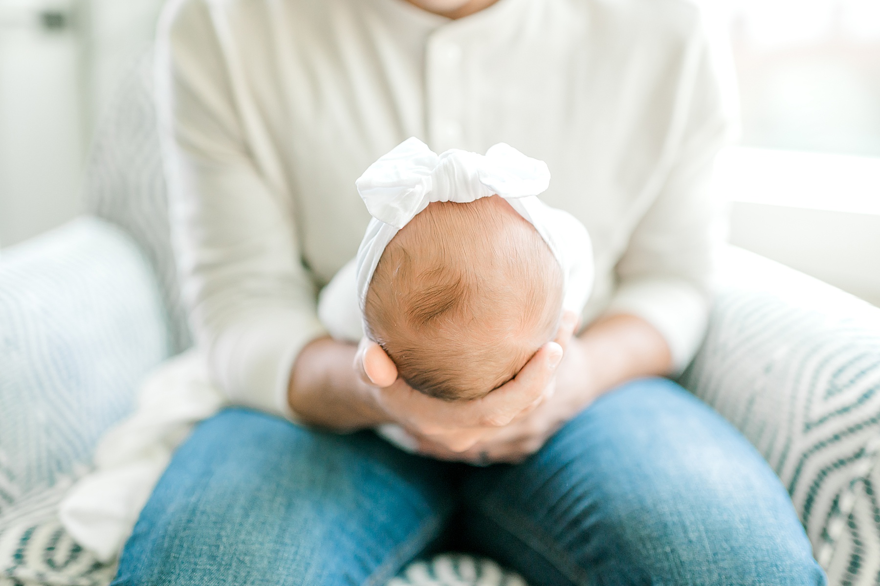 dad holds newborn in arms