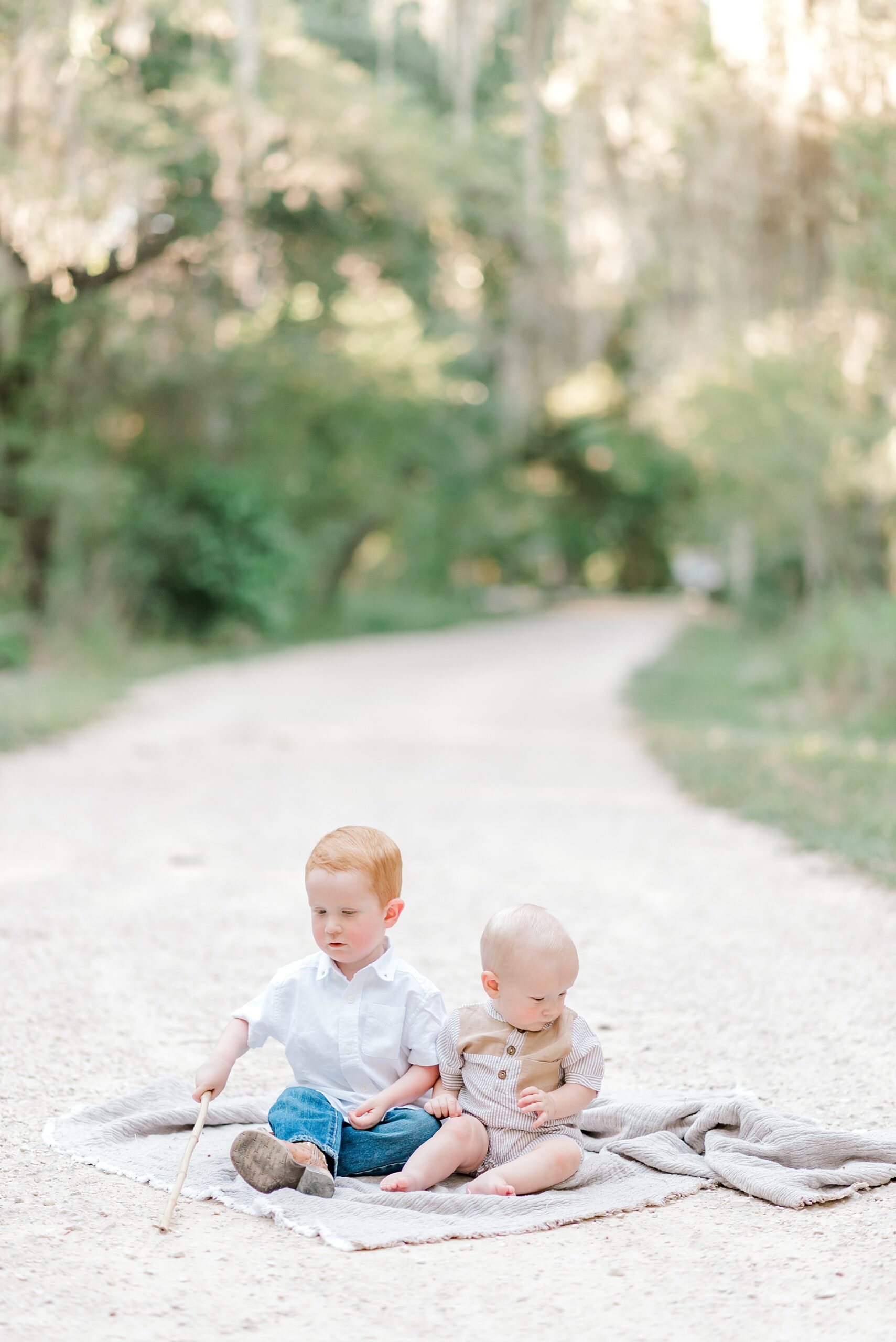 two brothers sit on blanket at  Brackenridge Park 