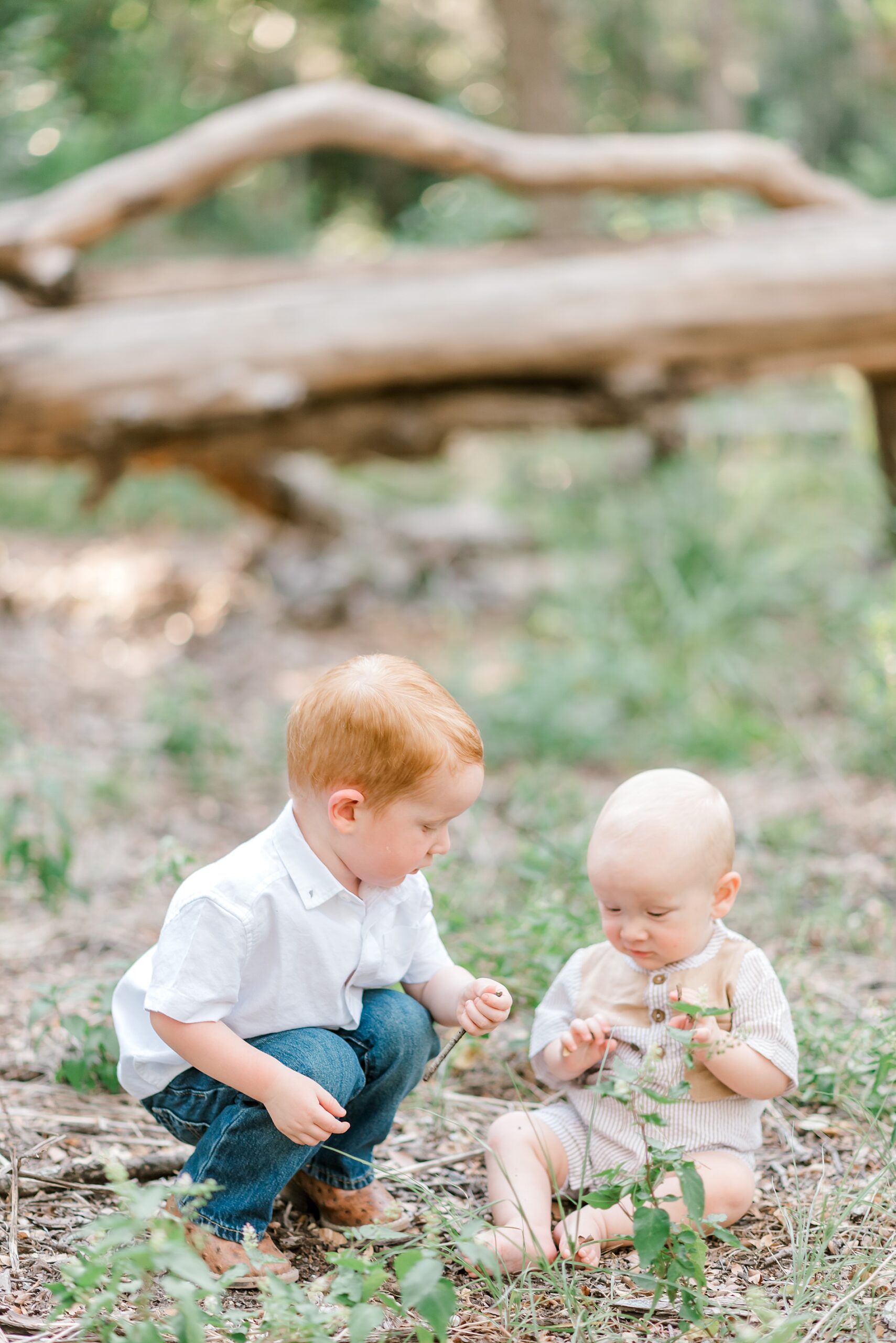 two kids play in grass during San Antonio, TX family session