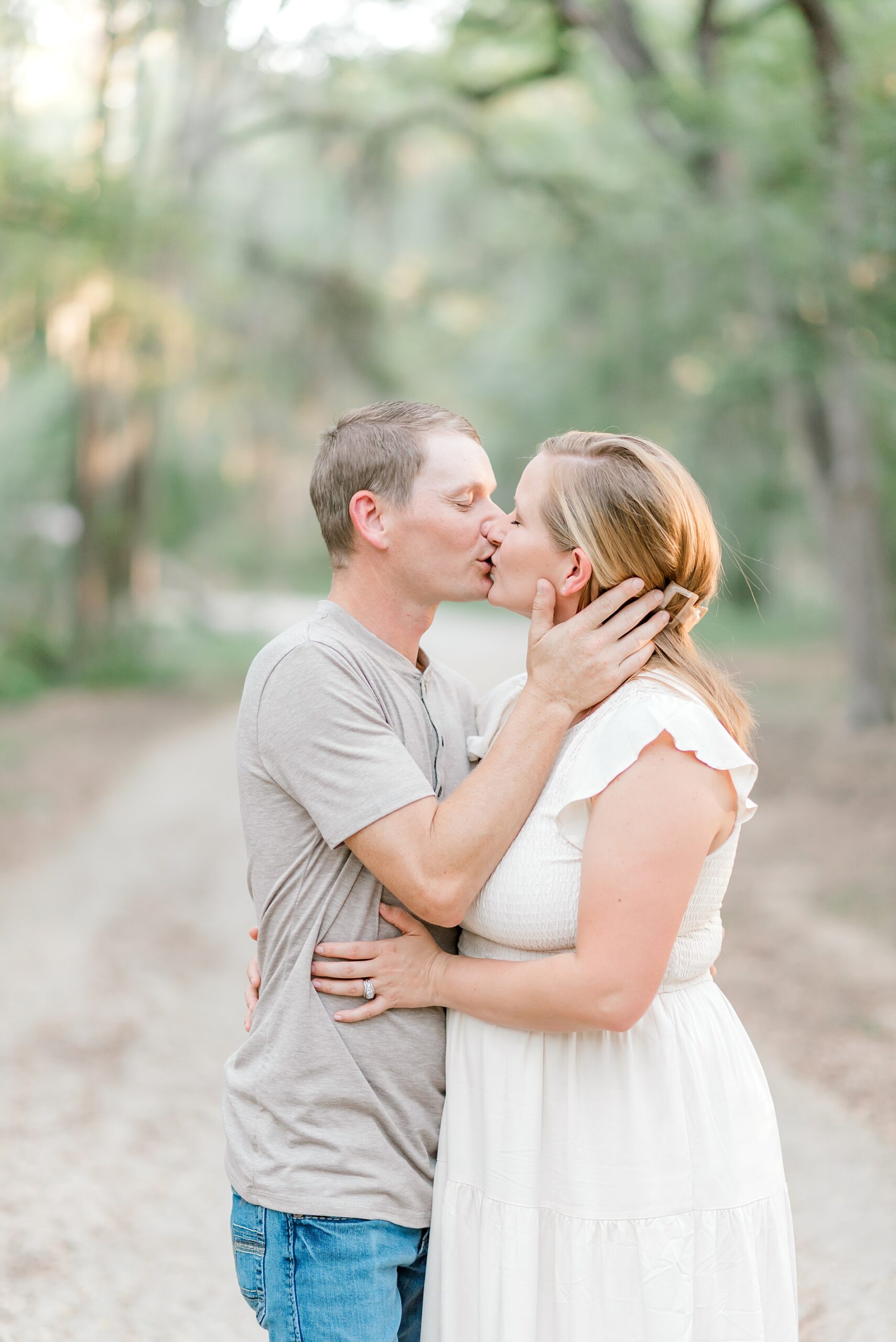 parents kiss during  Brackenridge Park Family Session in San Antonio TX  