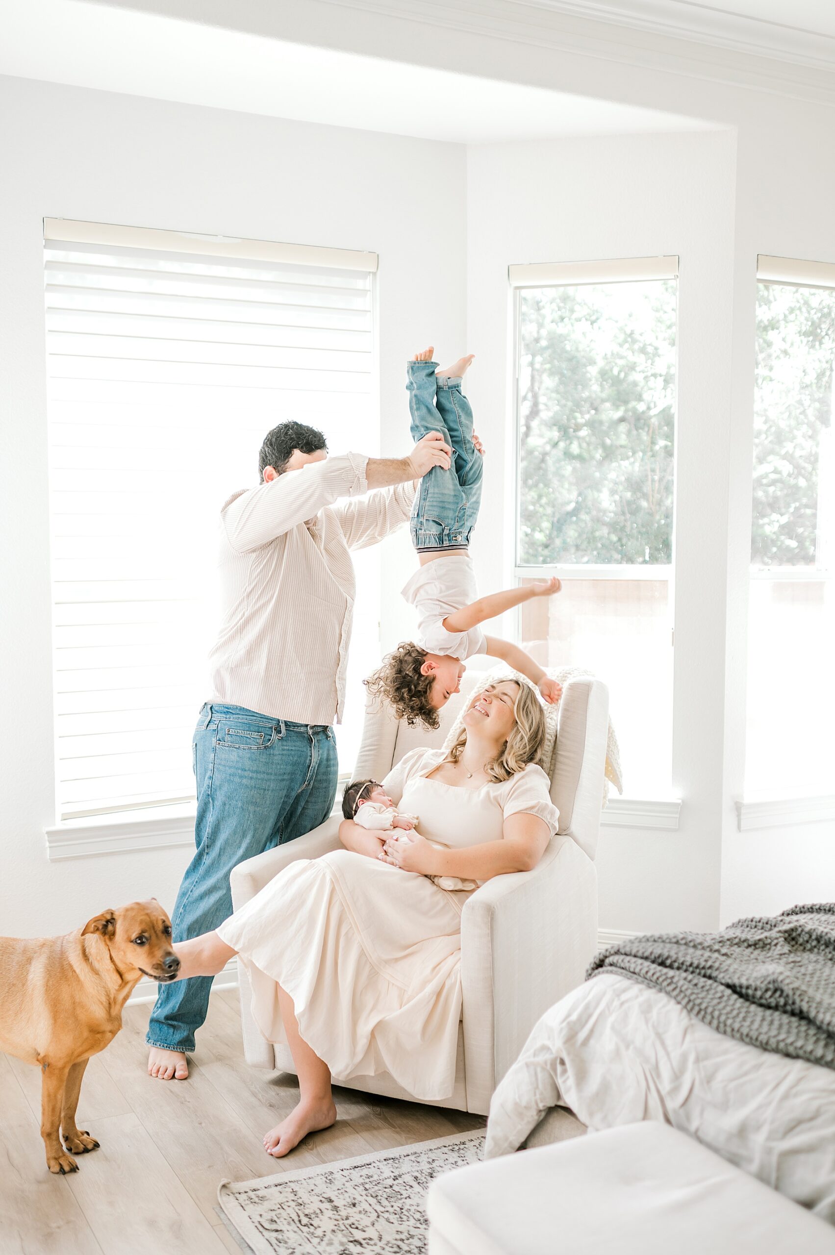 playful and candid family photo during in-home newborn session