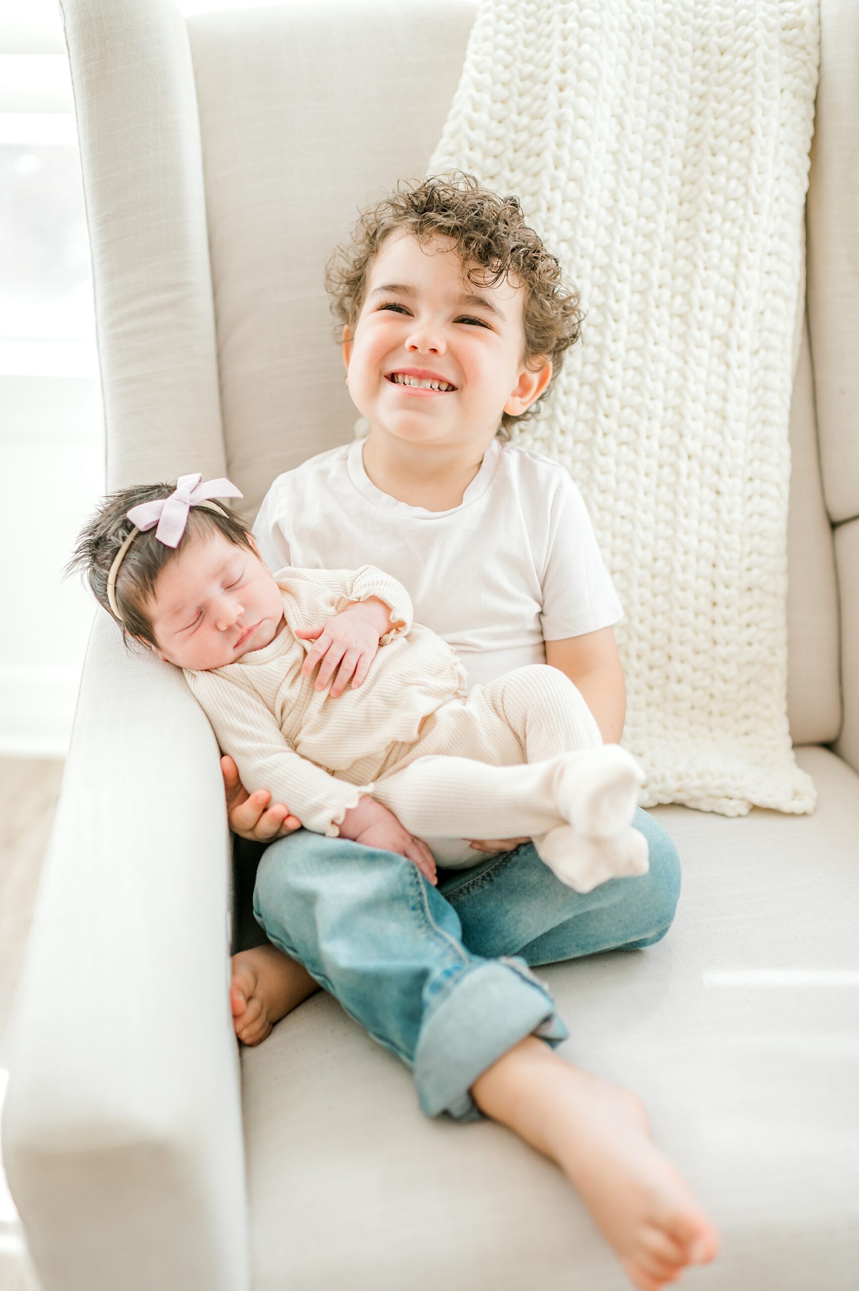 sibling portraits of older brother holding baby sister 