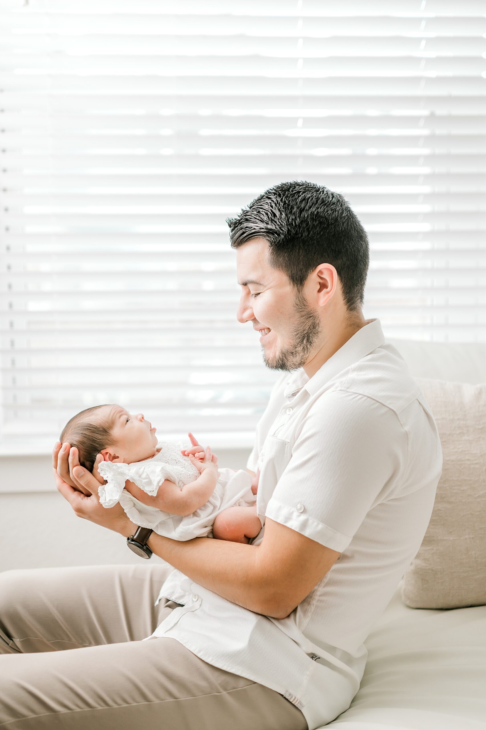 dad holds newborn girl