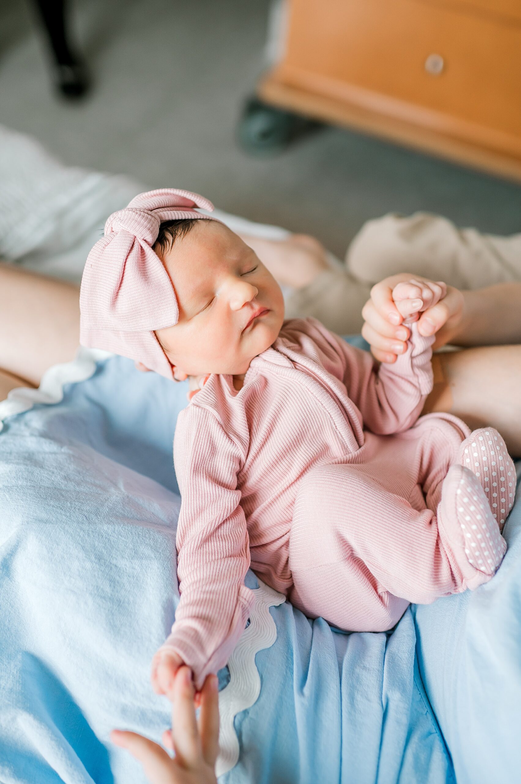 newborn girl in pink outfit