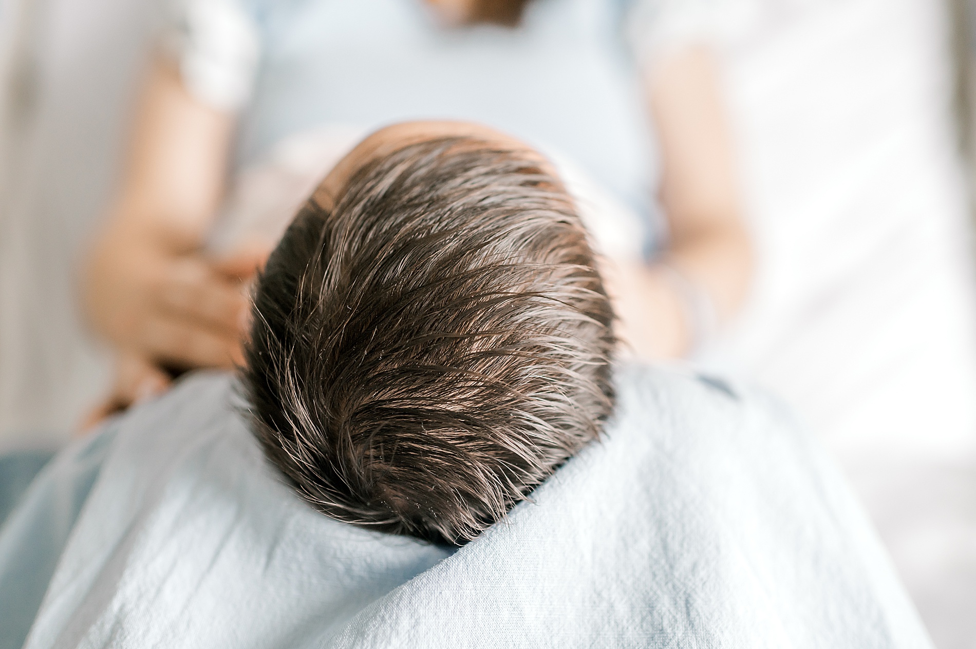 newborn girl in mom's lap