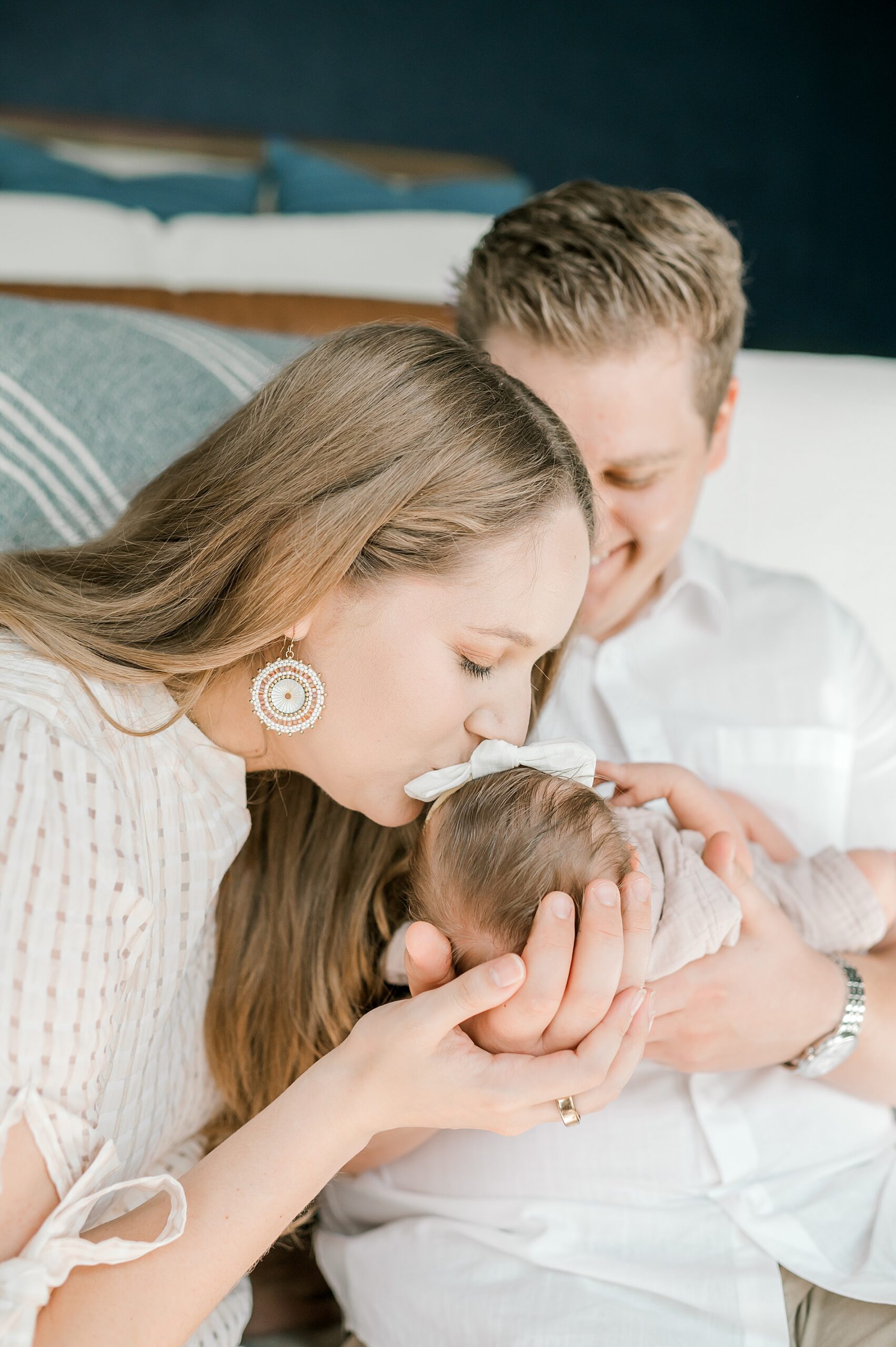 mom kisses baby girl's head