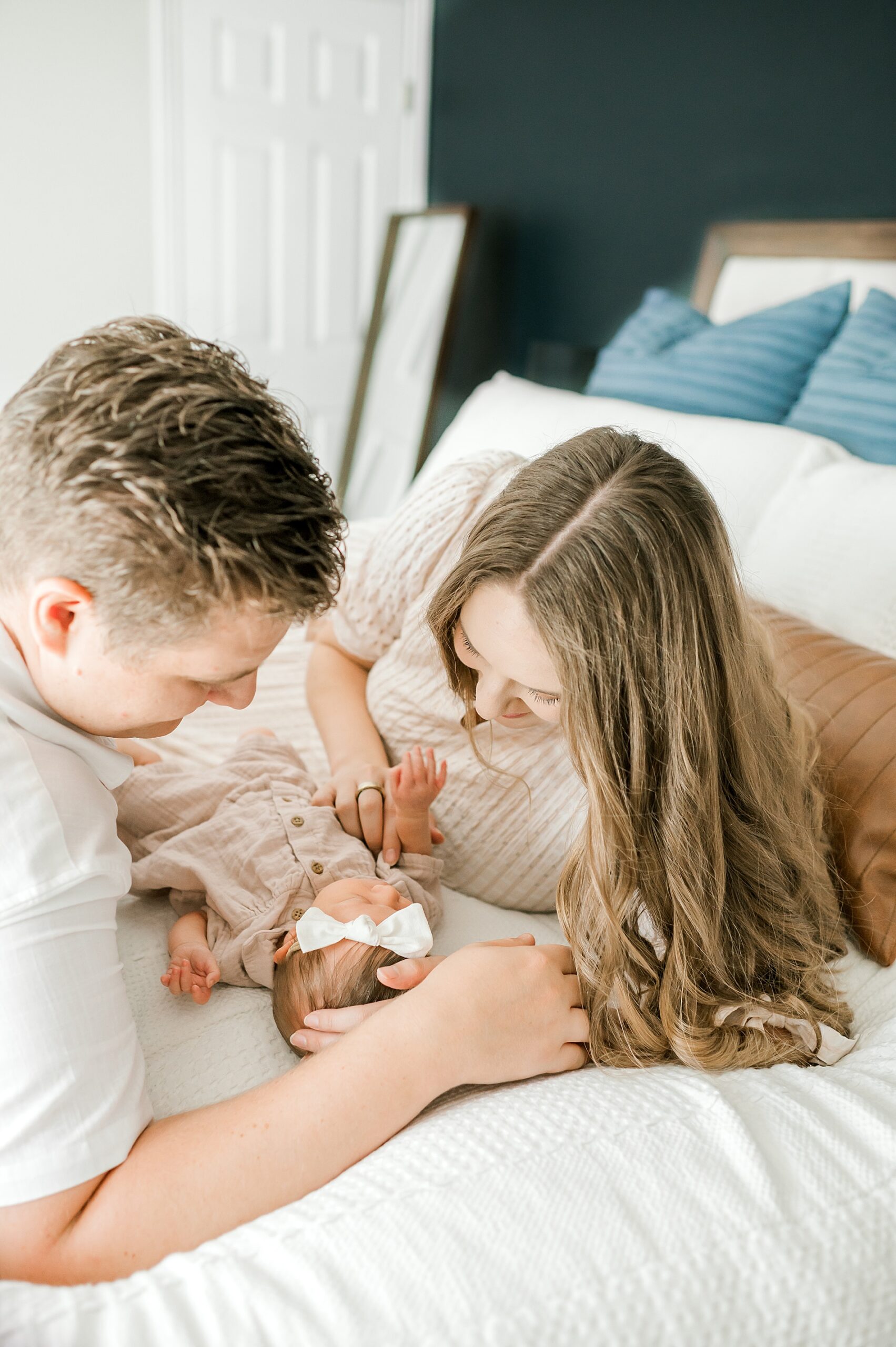 parents look down at their newborn girl 