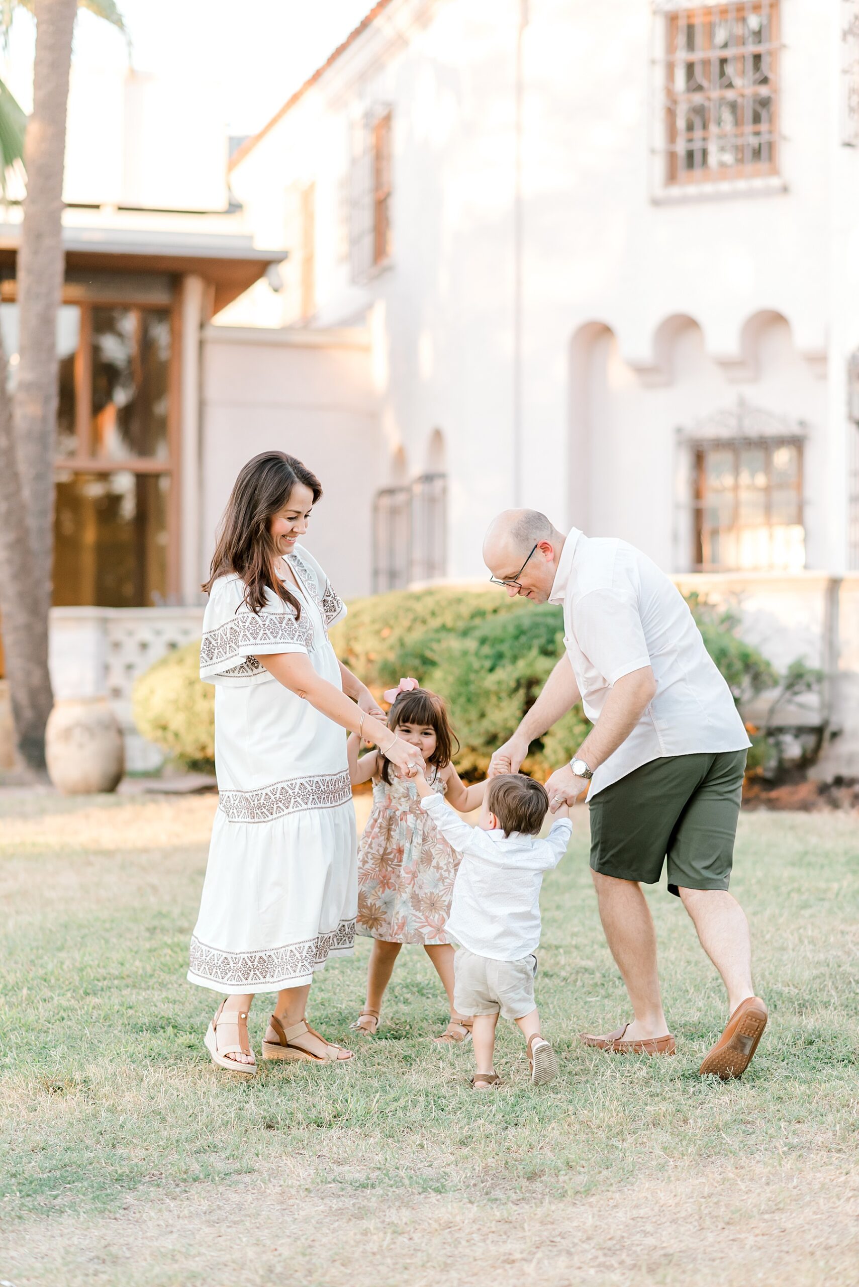 family of four spin together in a circle as they hold hands