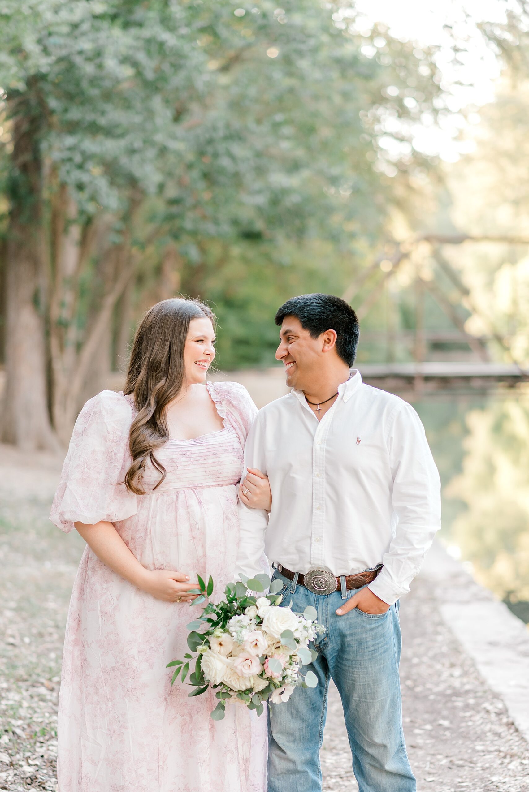 couple link arms during Brackenridge Park Maternity Session