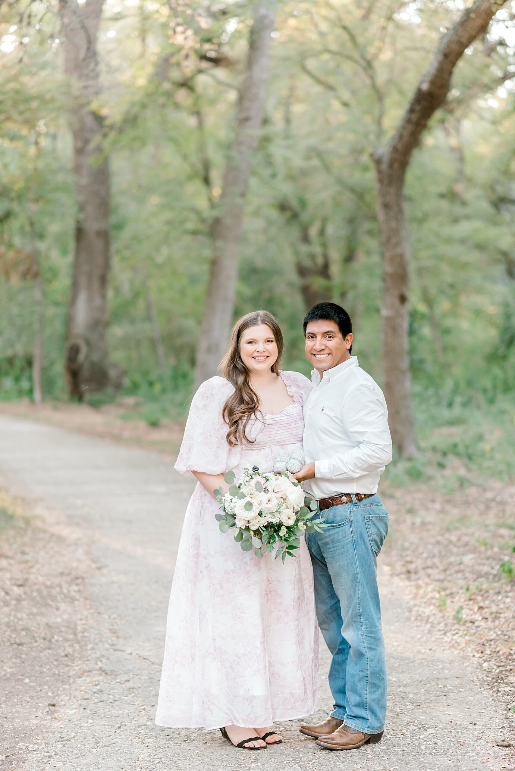 couple stand on trail for maternity portraits at Brackenridge Park 