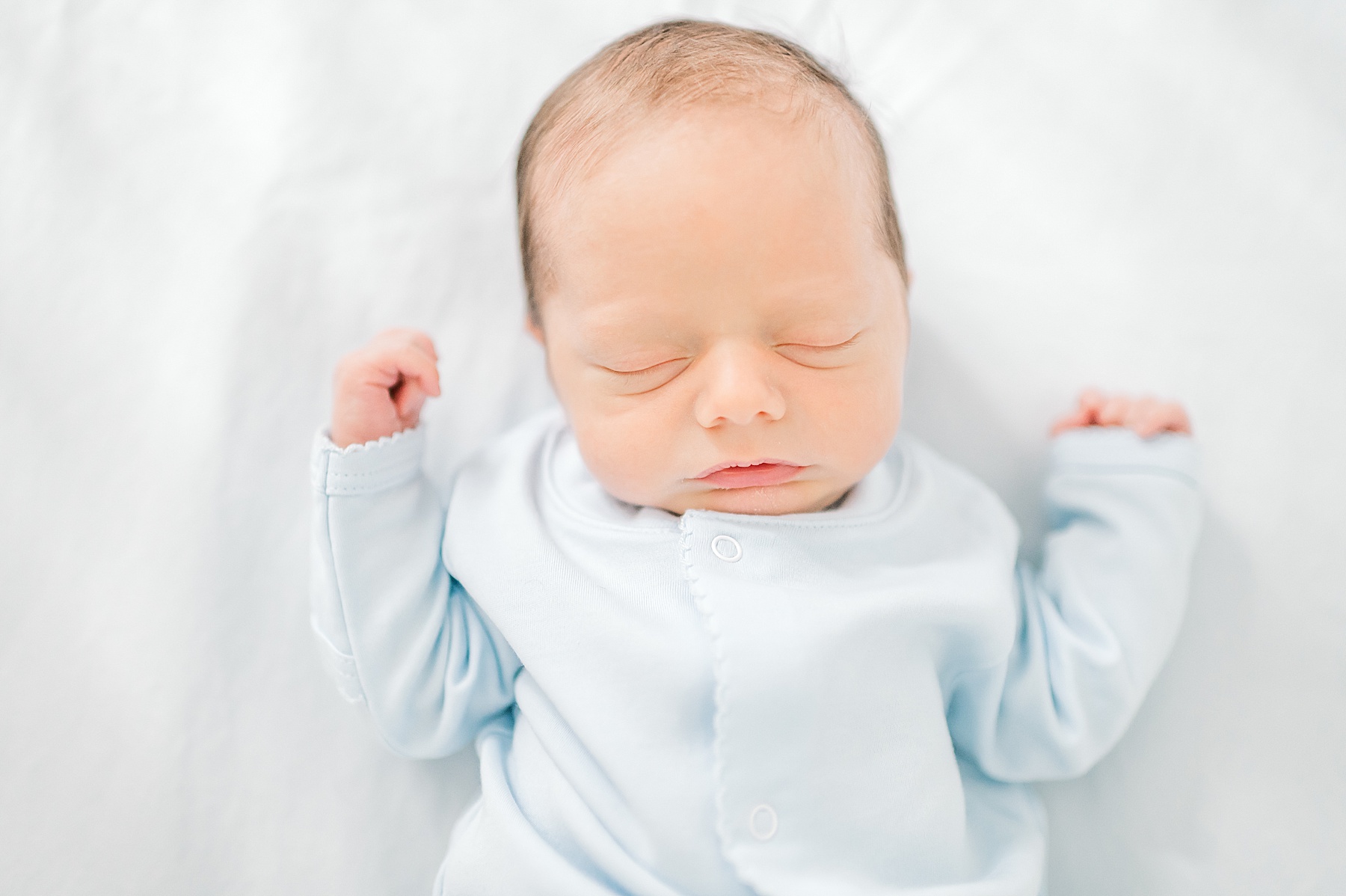 baby boy in blue onsie