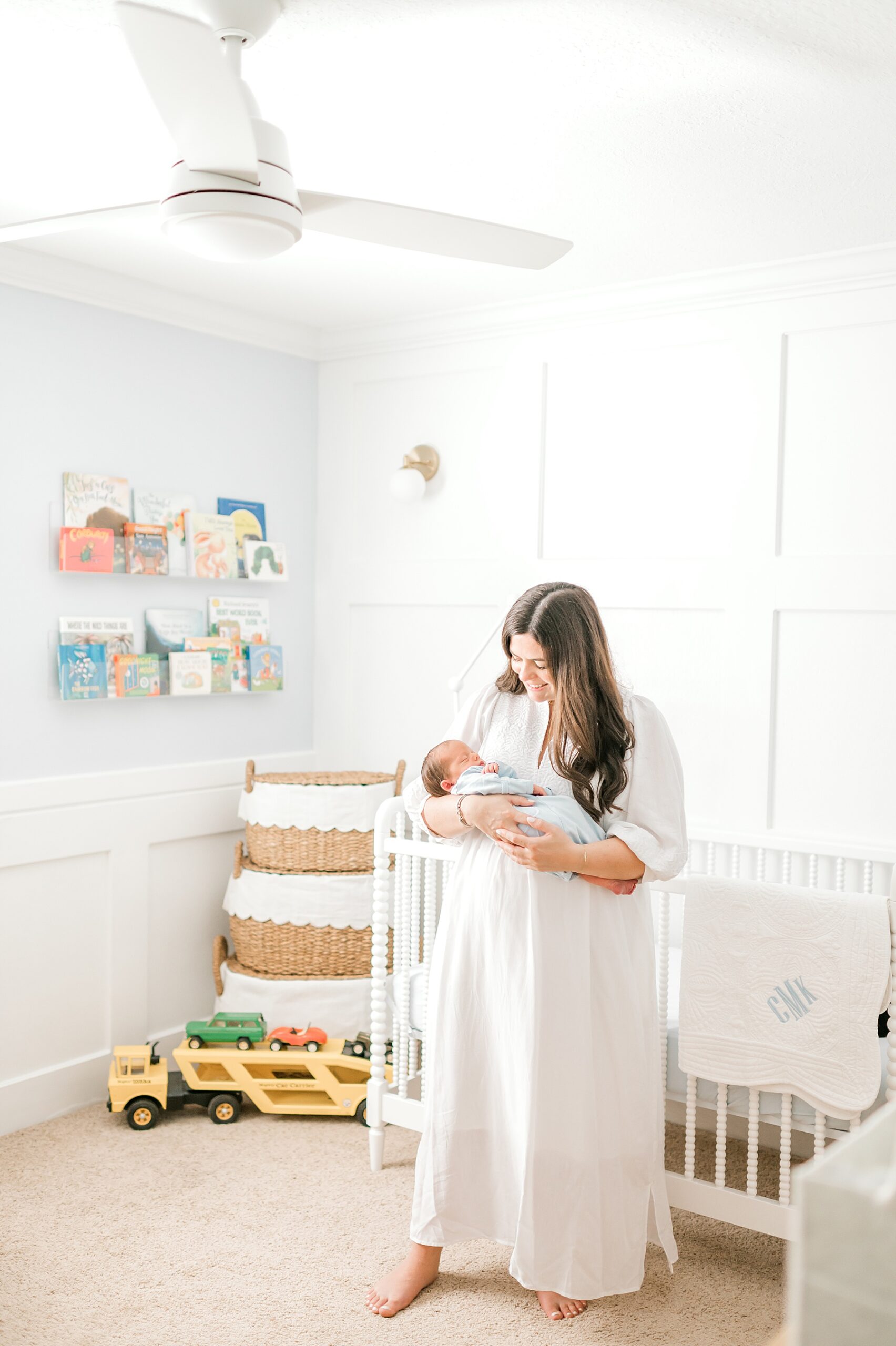 mom holds newborn in nursery