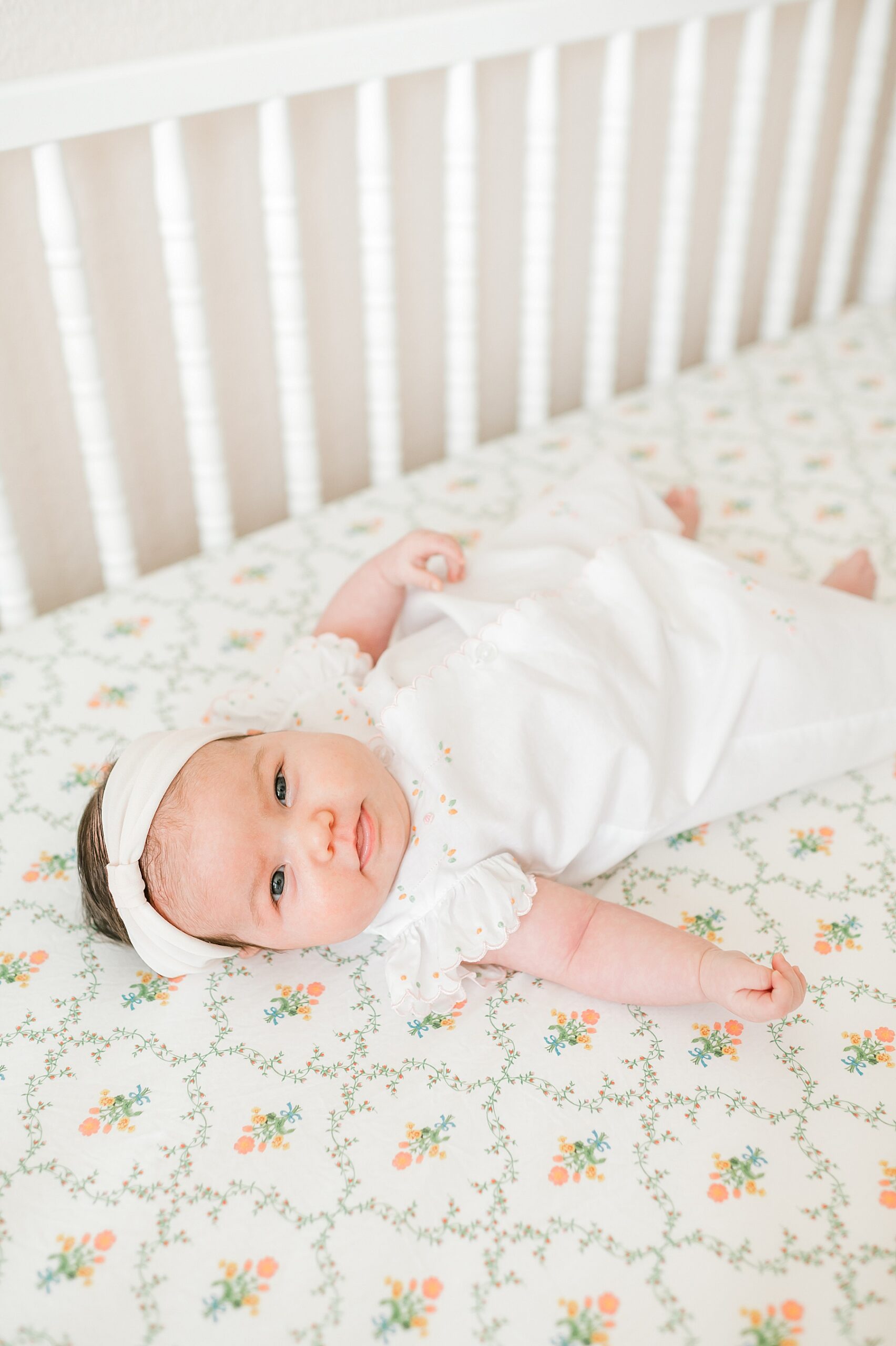 baby girl lays in crib