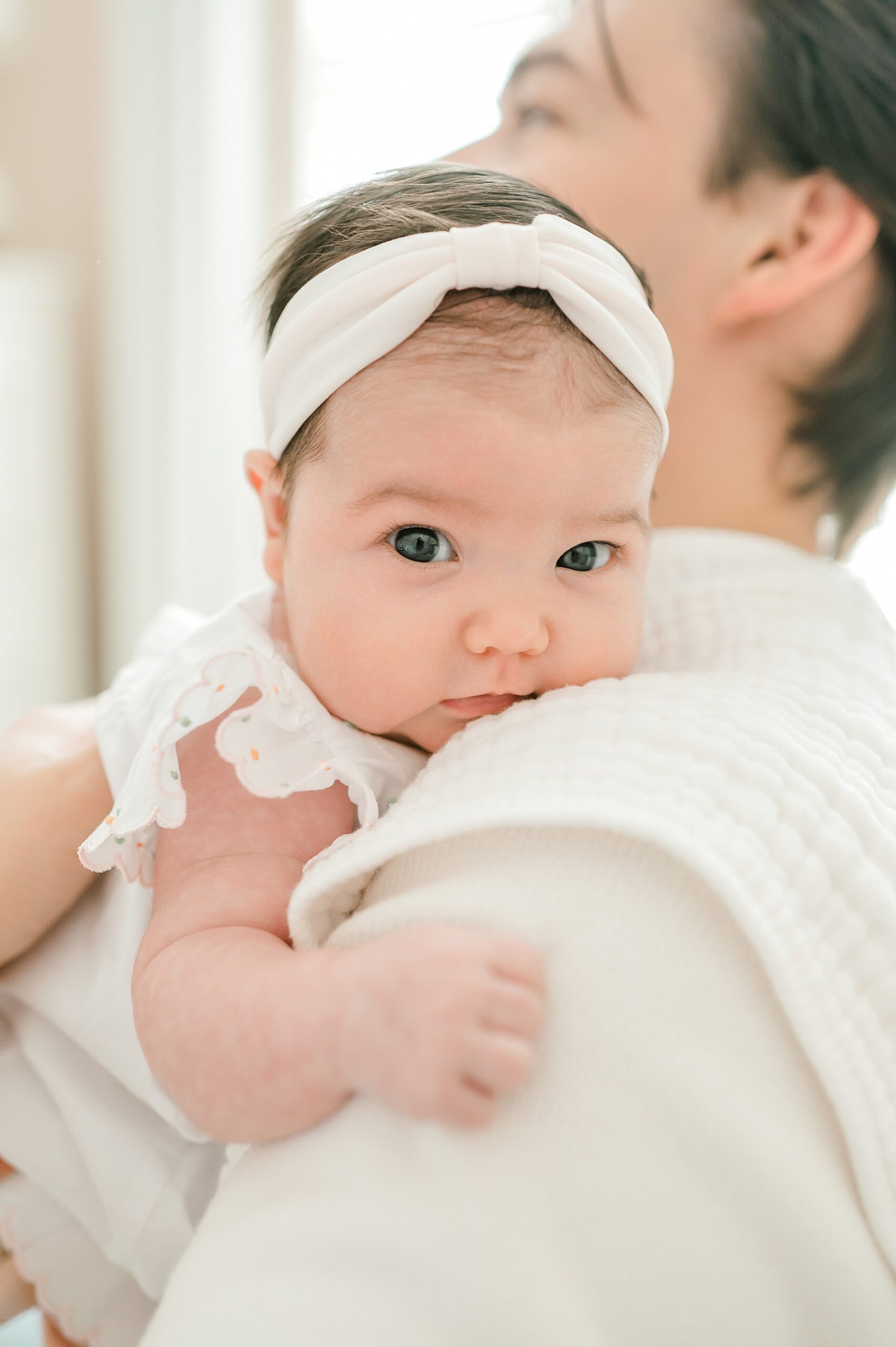 baby girl looks around as dad holds her