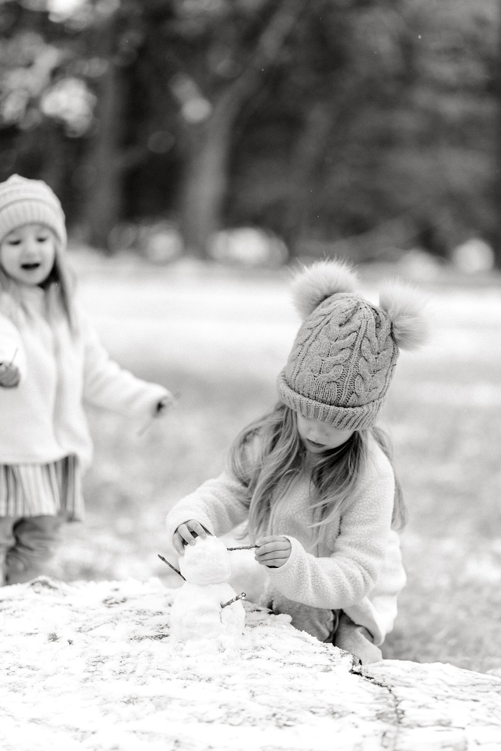 candid family photos of girls playing in snow