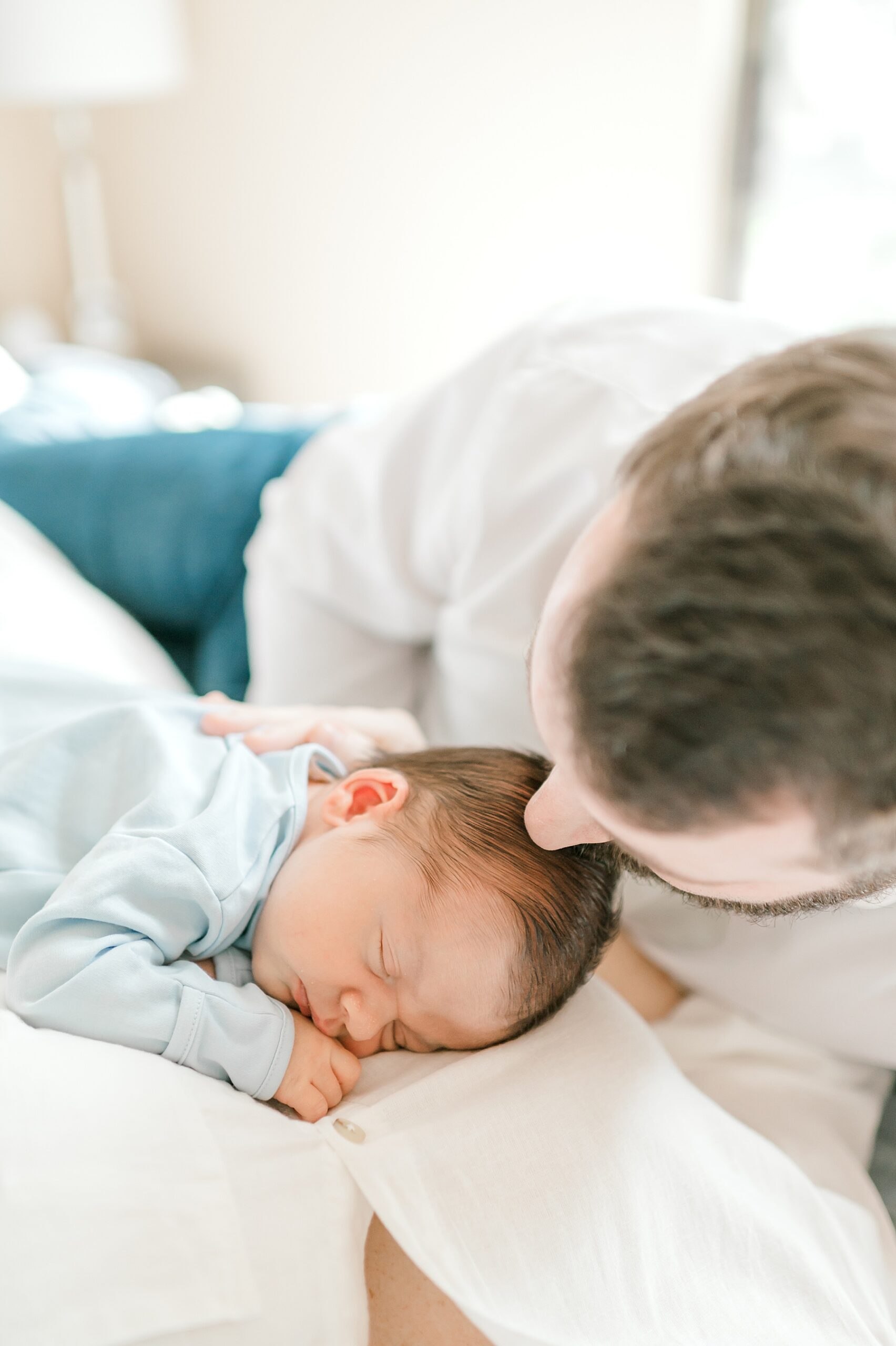 dad kisses newborn's head 