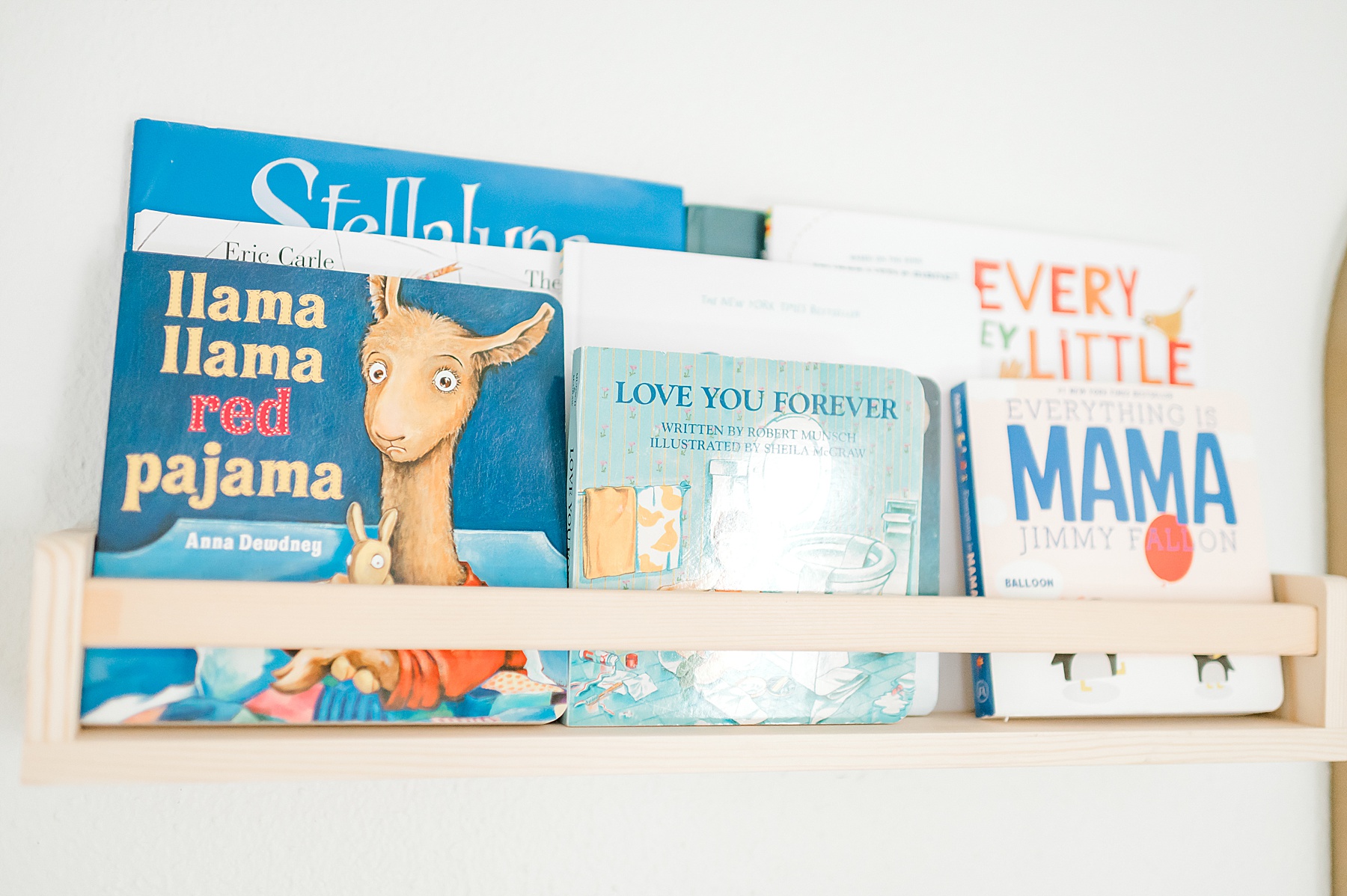 wall shelf holding books in nursery