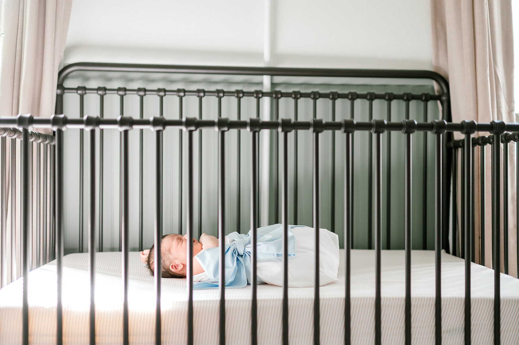 newborn boy sleeps in crib