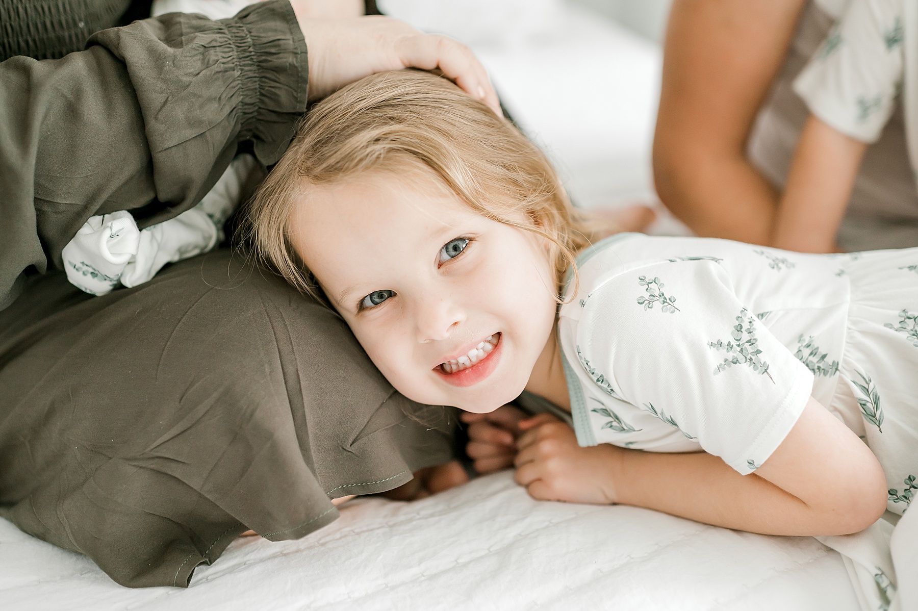 candid photo of little girl during brother's newborn session