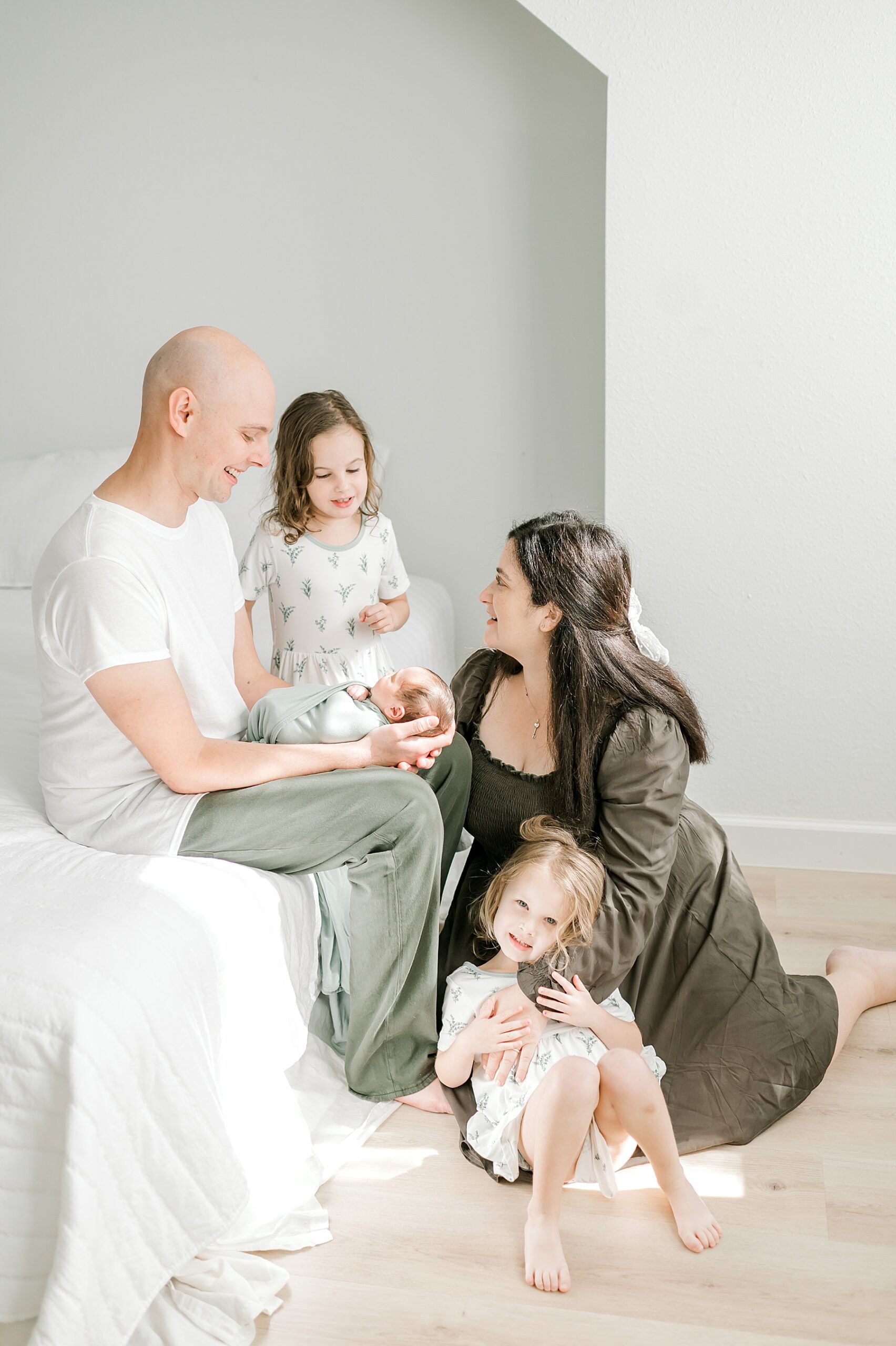 dad holds newborn boy surrounded by mom and siblings 