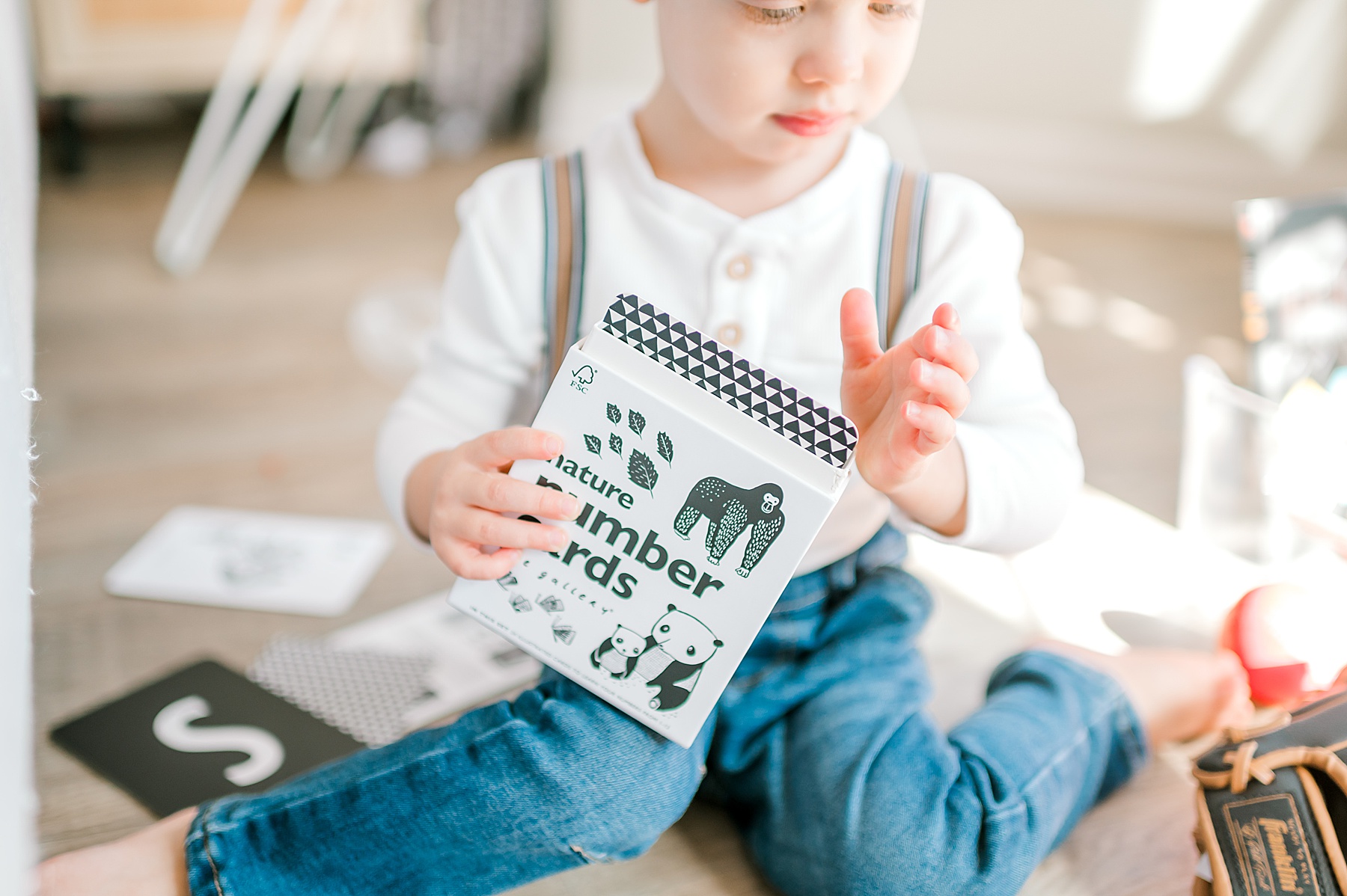 older child playing with toys during Candid In-Home Newborn Session | Lifestyle Newborn Photography