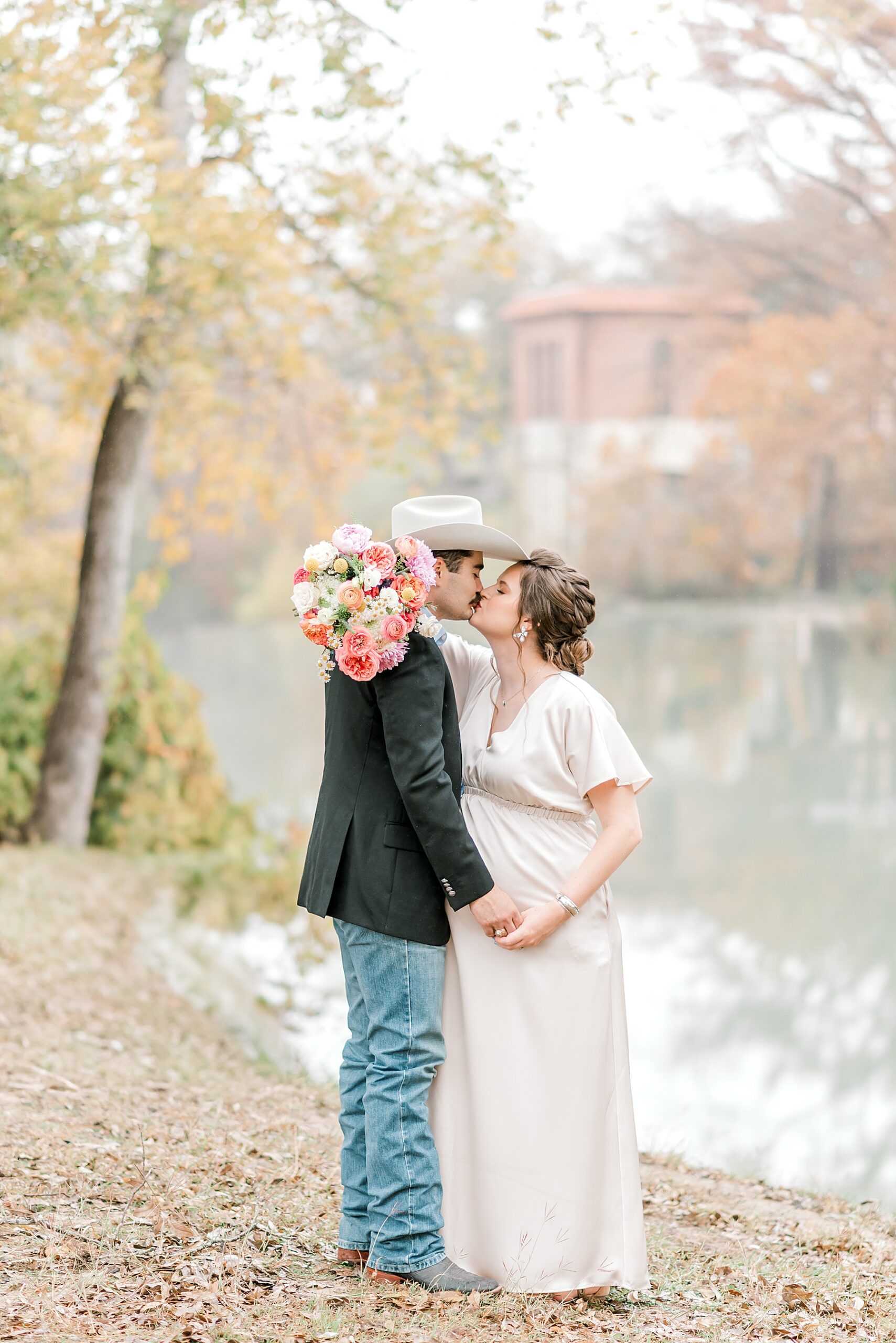 couple kiss during Heartfelt Maternity Session at Max Starcke Park