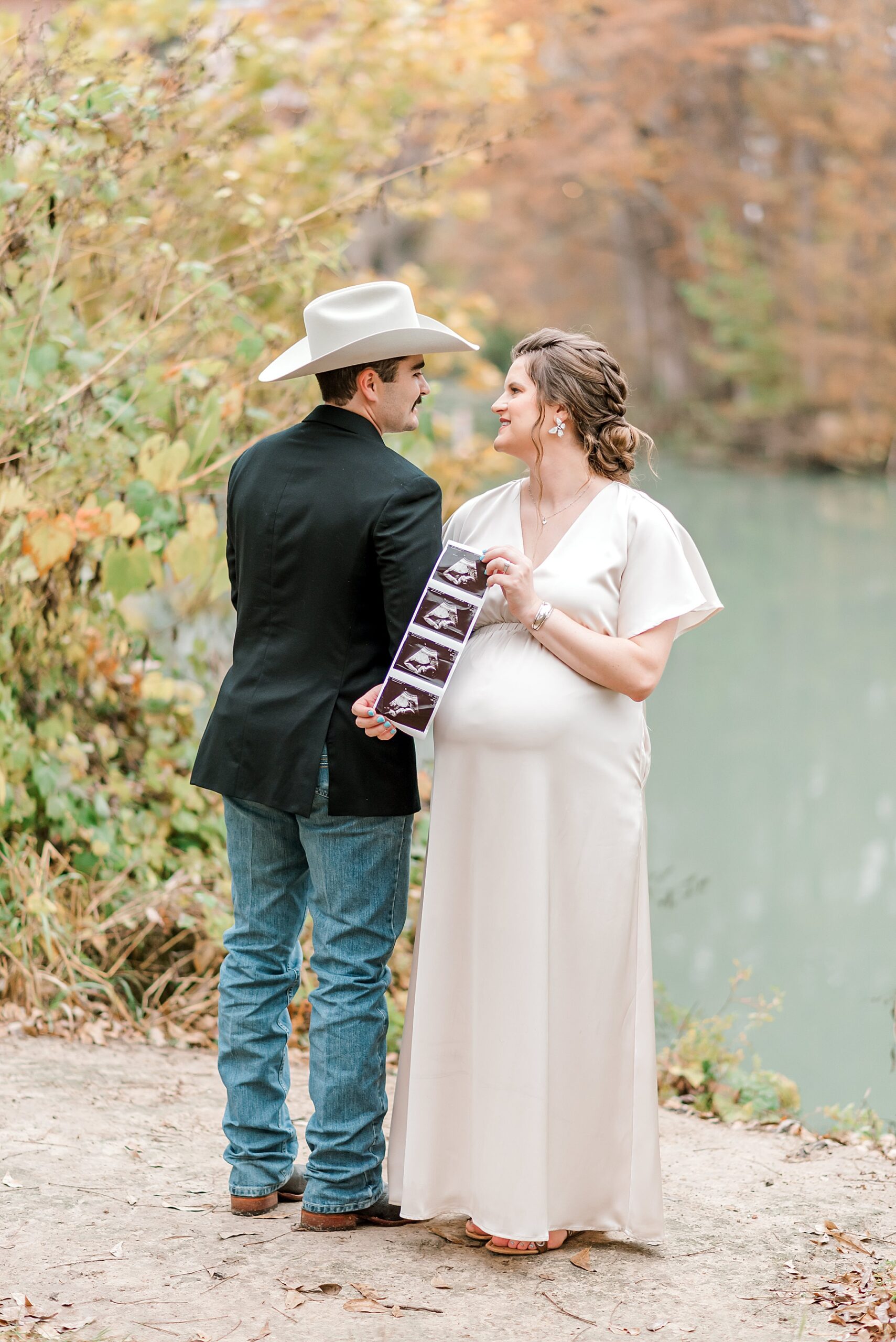 couple show off ultrasound photo of baby 