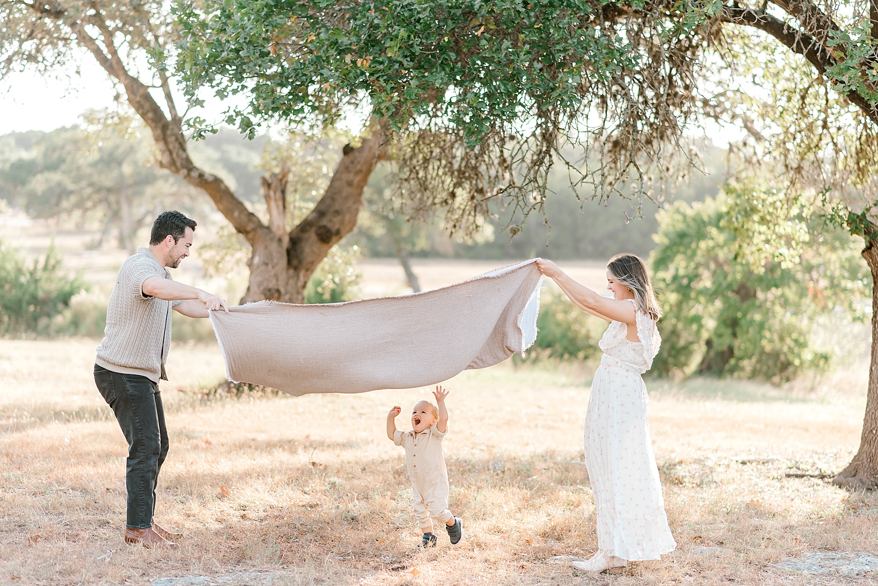 parents play with son during family portrait session