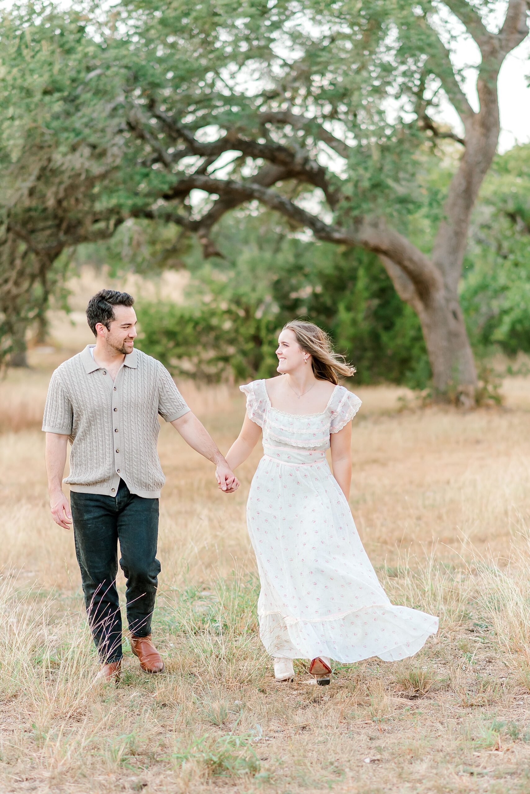 husband and wife hold hands during family session 