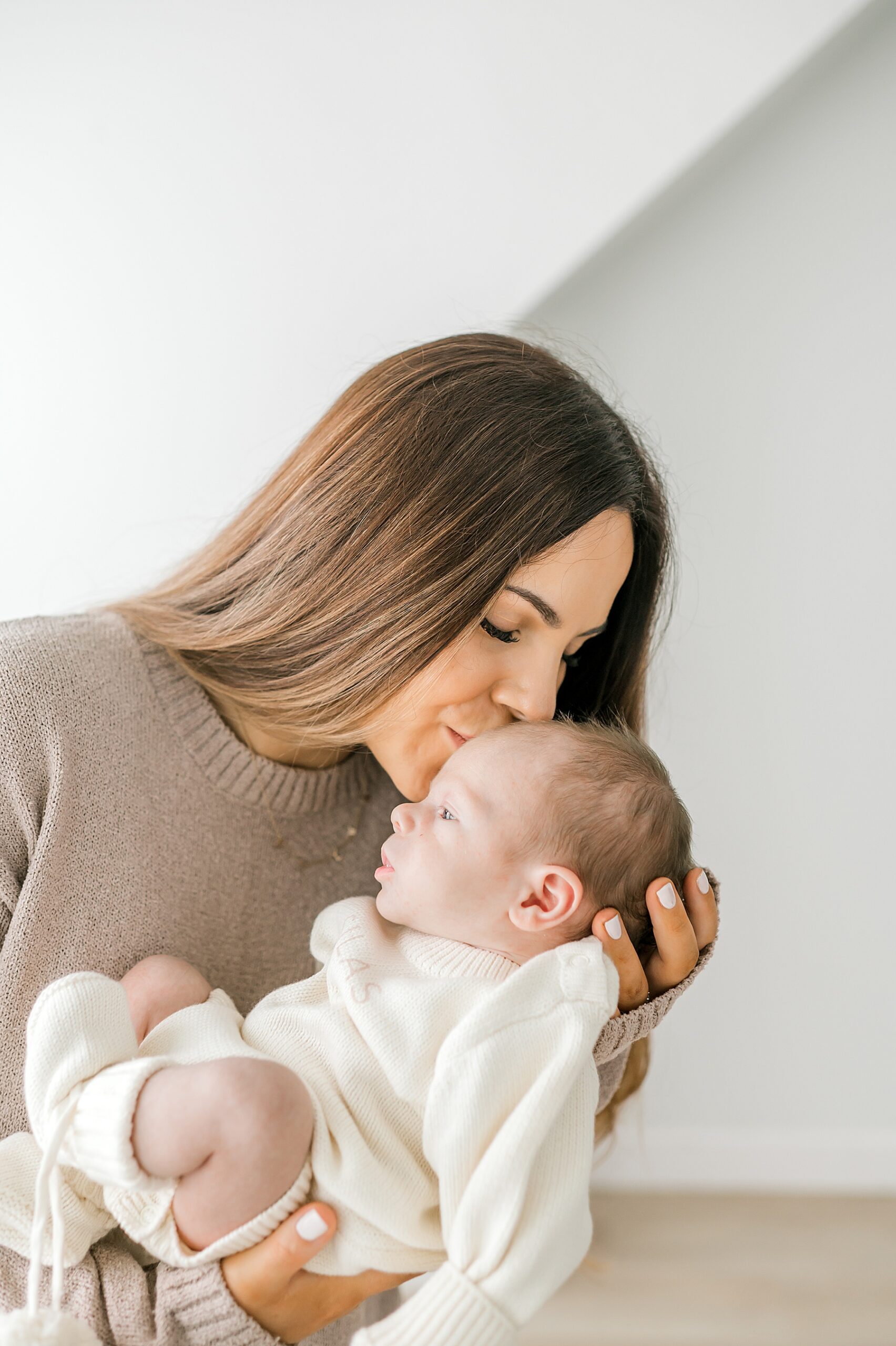 mom kisses newborn's head