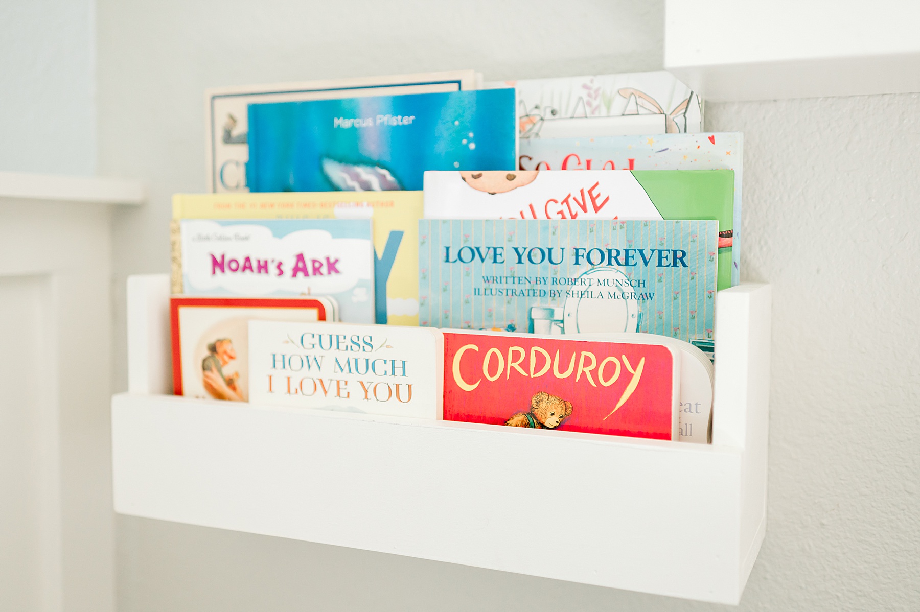 books in white shelf