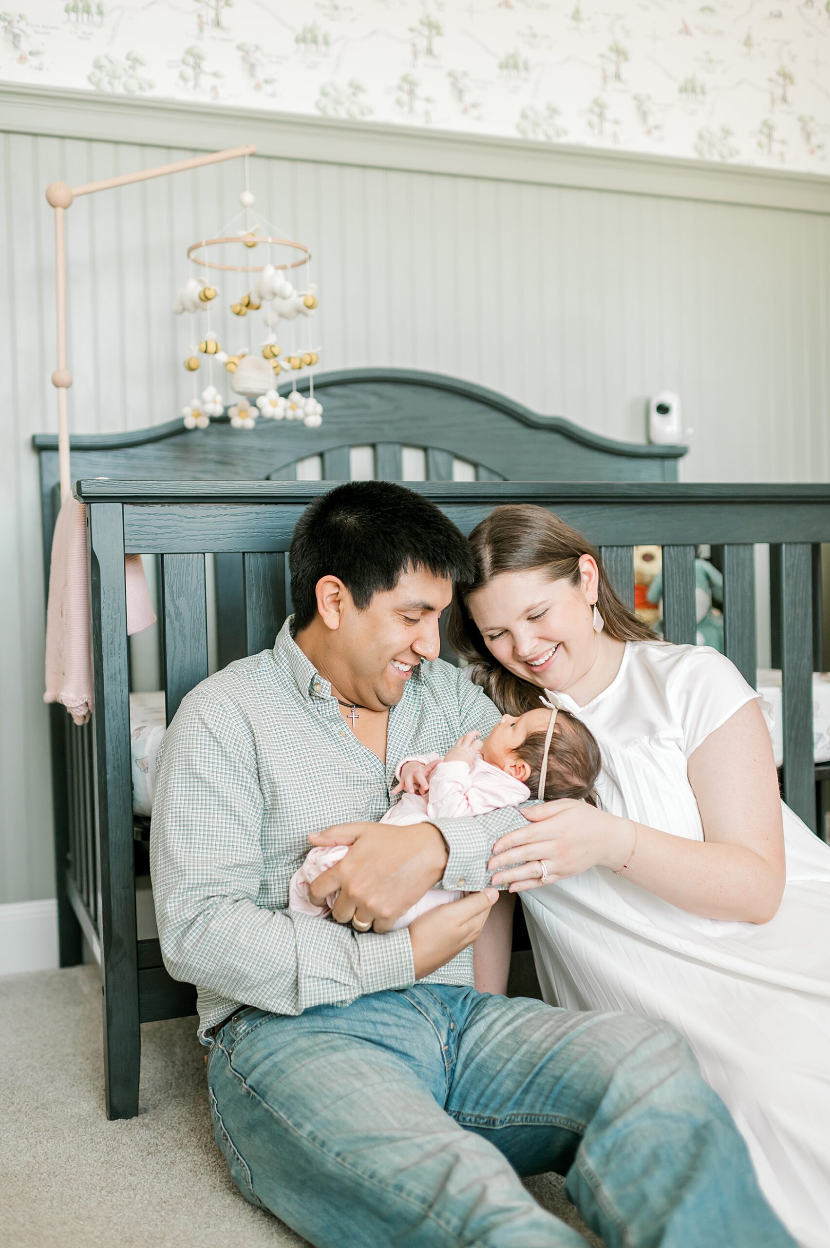 new parents sit on nursery floor holding baby girl | Why Awake Babies Are Just As Perfect