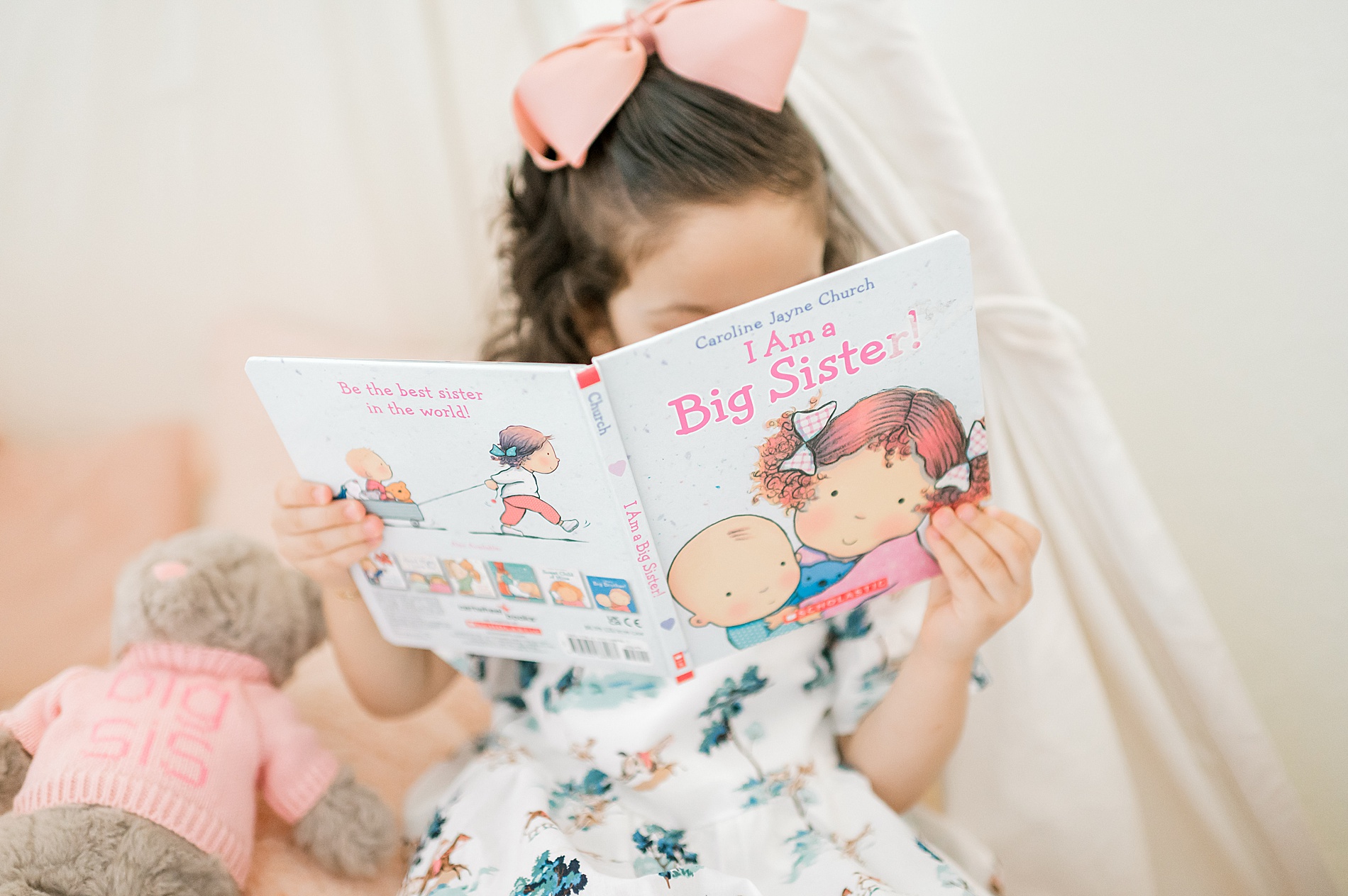 toddler reading big sister book