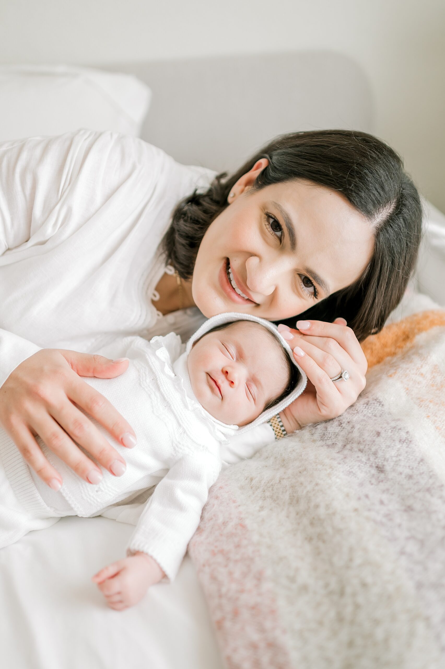 mom with newborn in white | What to Wear for Your Lifestyle Newborn Session
