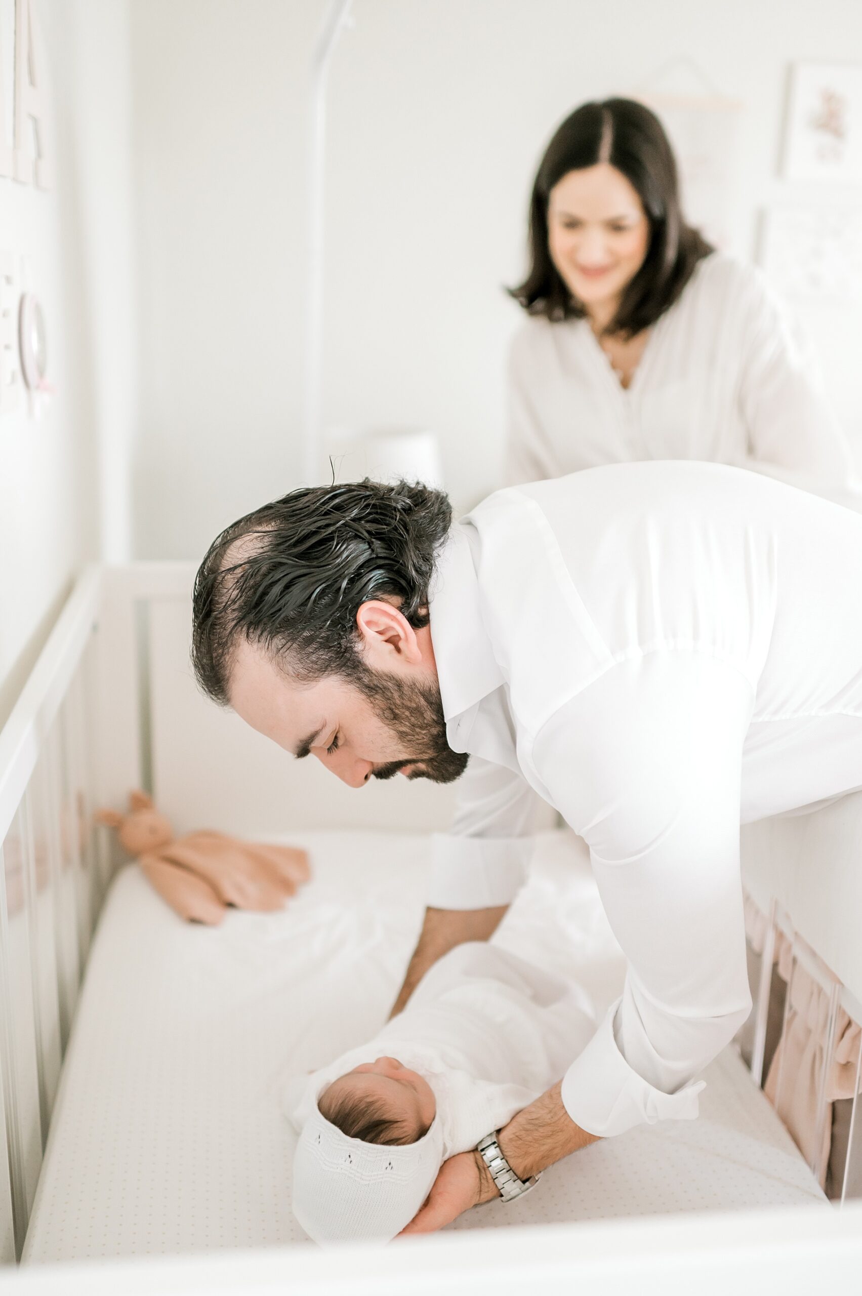 dad puts newborn in crib