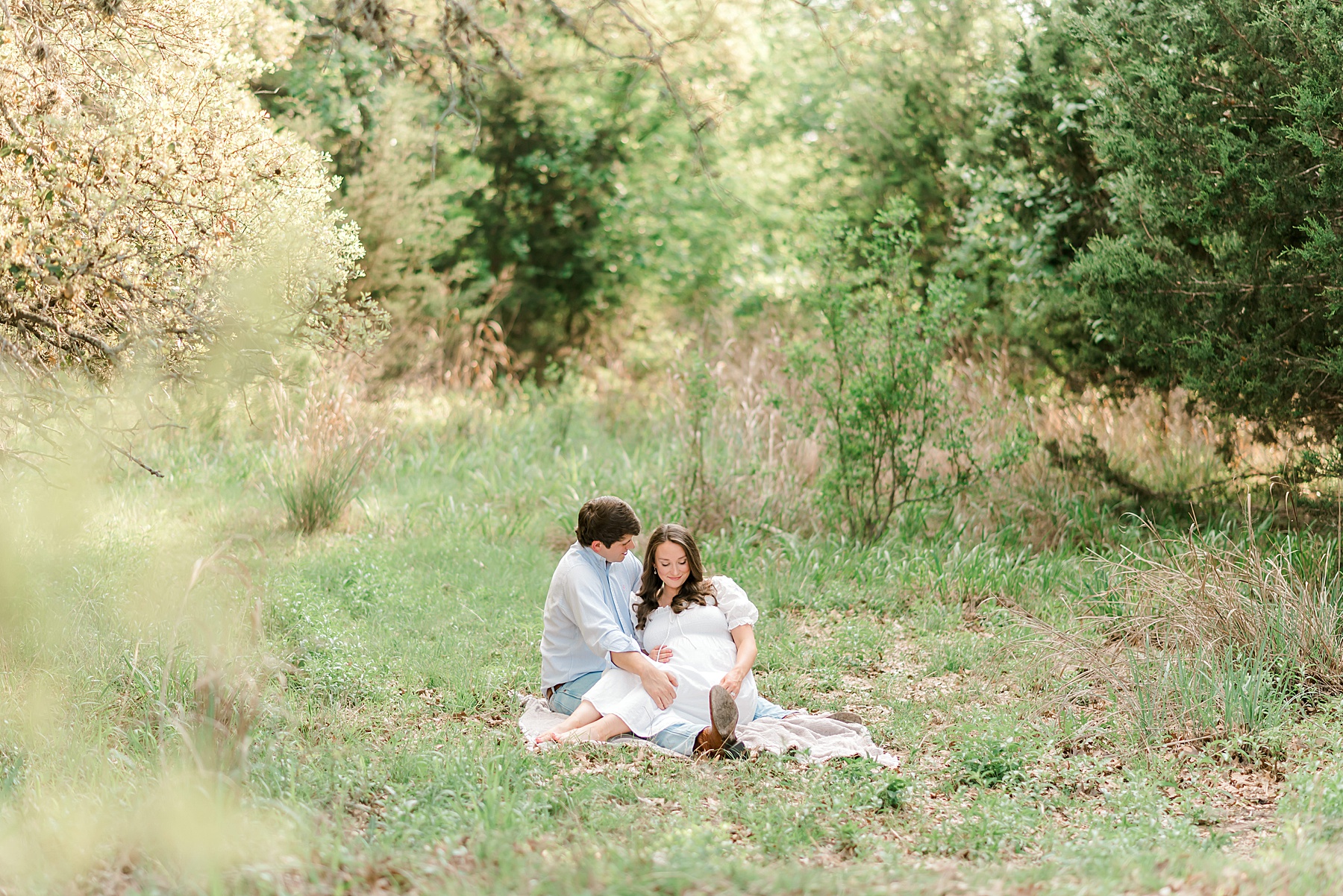couple sit together on blanket in the grass at Cibolo Nature Center