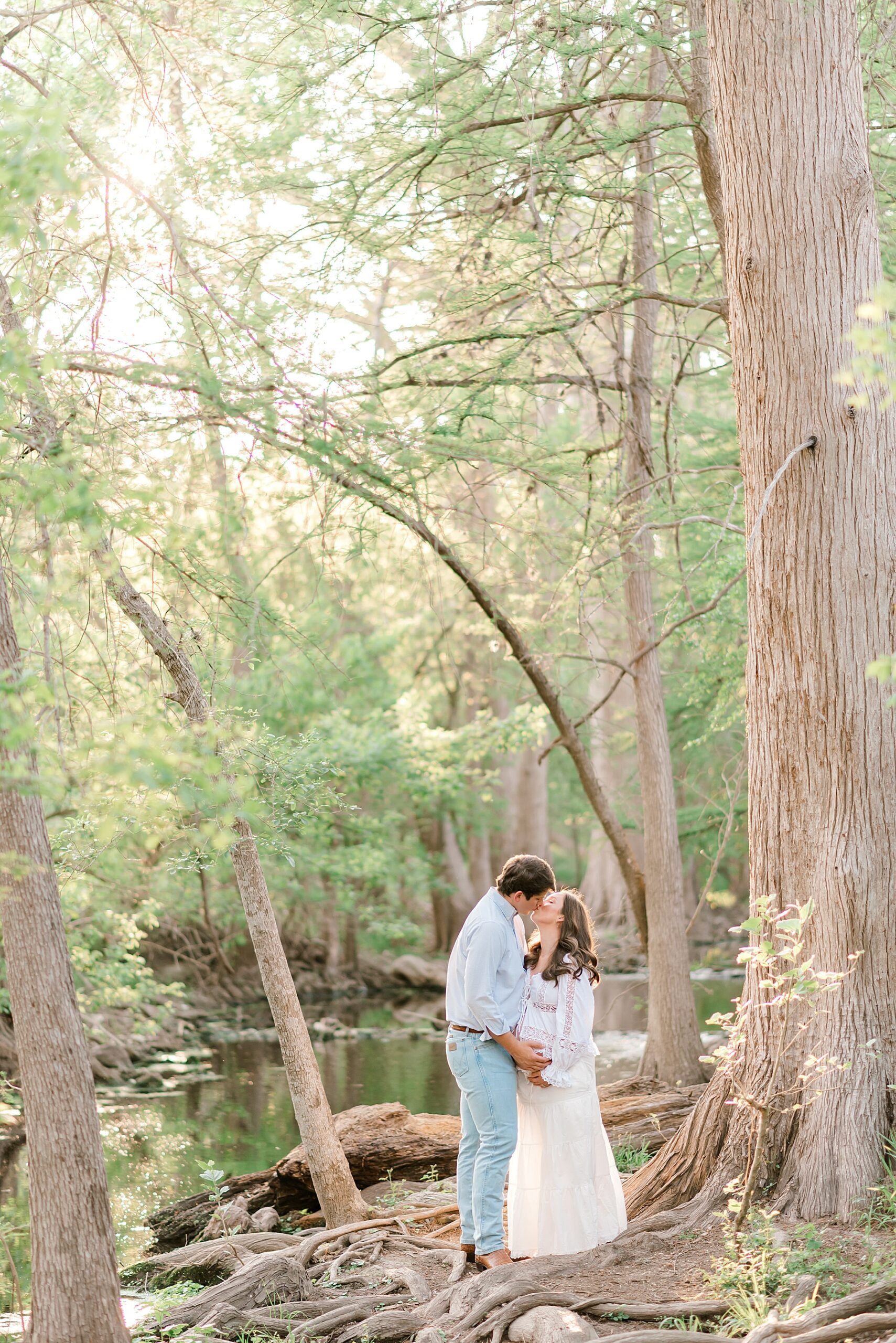 dreamy maternity portraits in woods under large trees