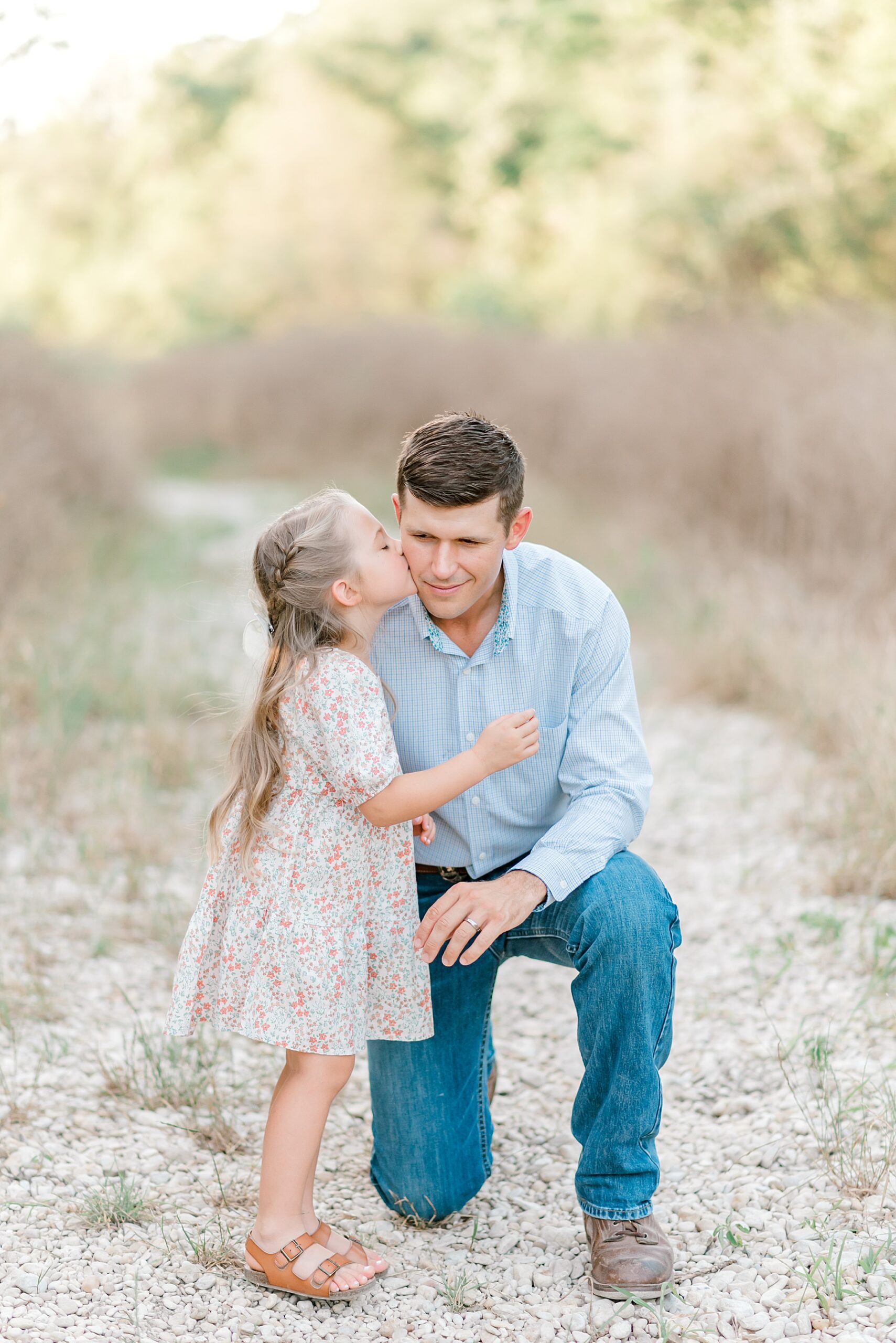 little girl kisses dad's cheek