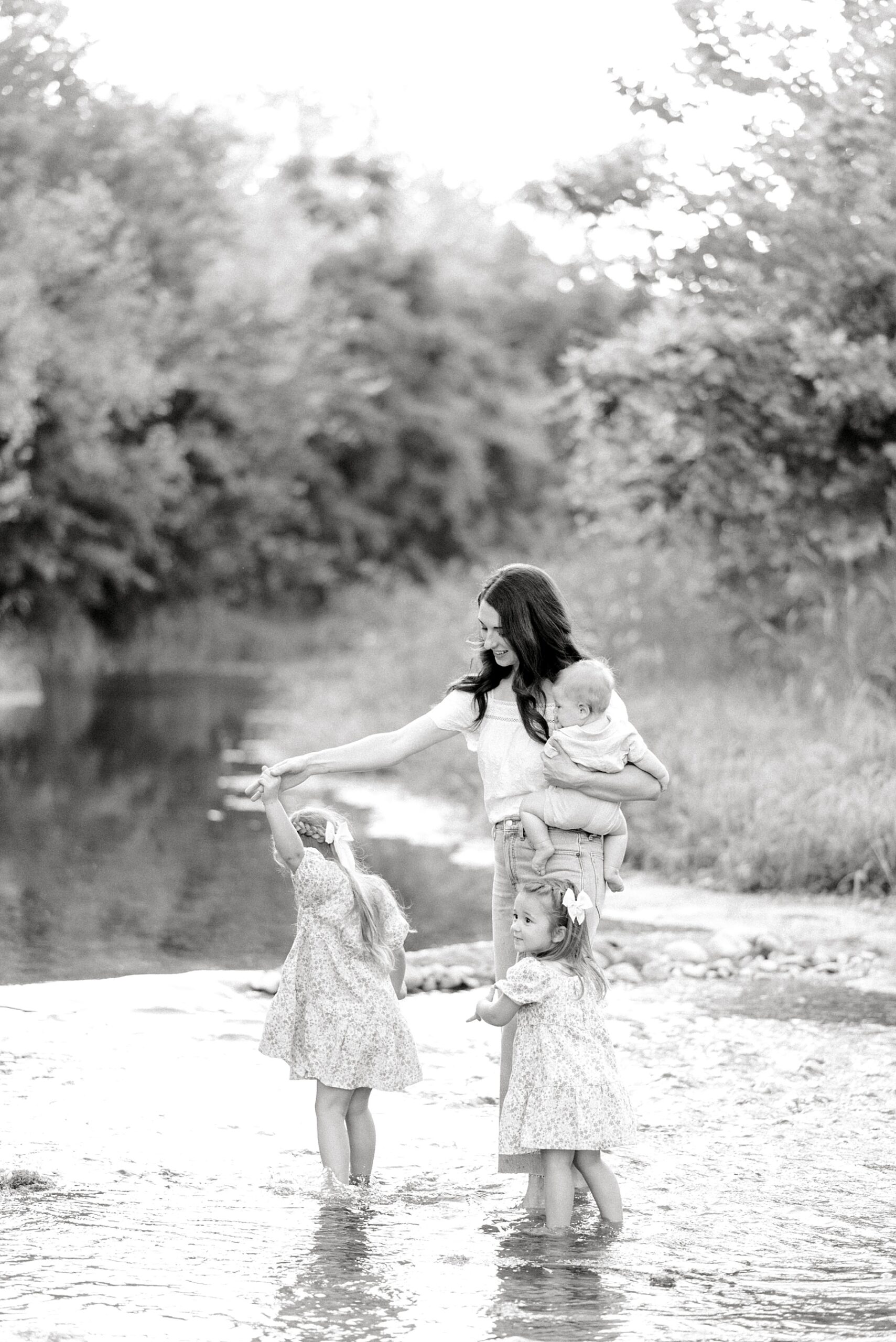 mom with her kids in the river | How to Choose the Right Season and Setting for Family Photos | Crescent Bend Family Session by the River